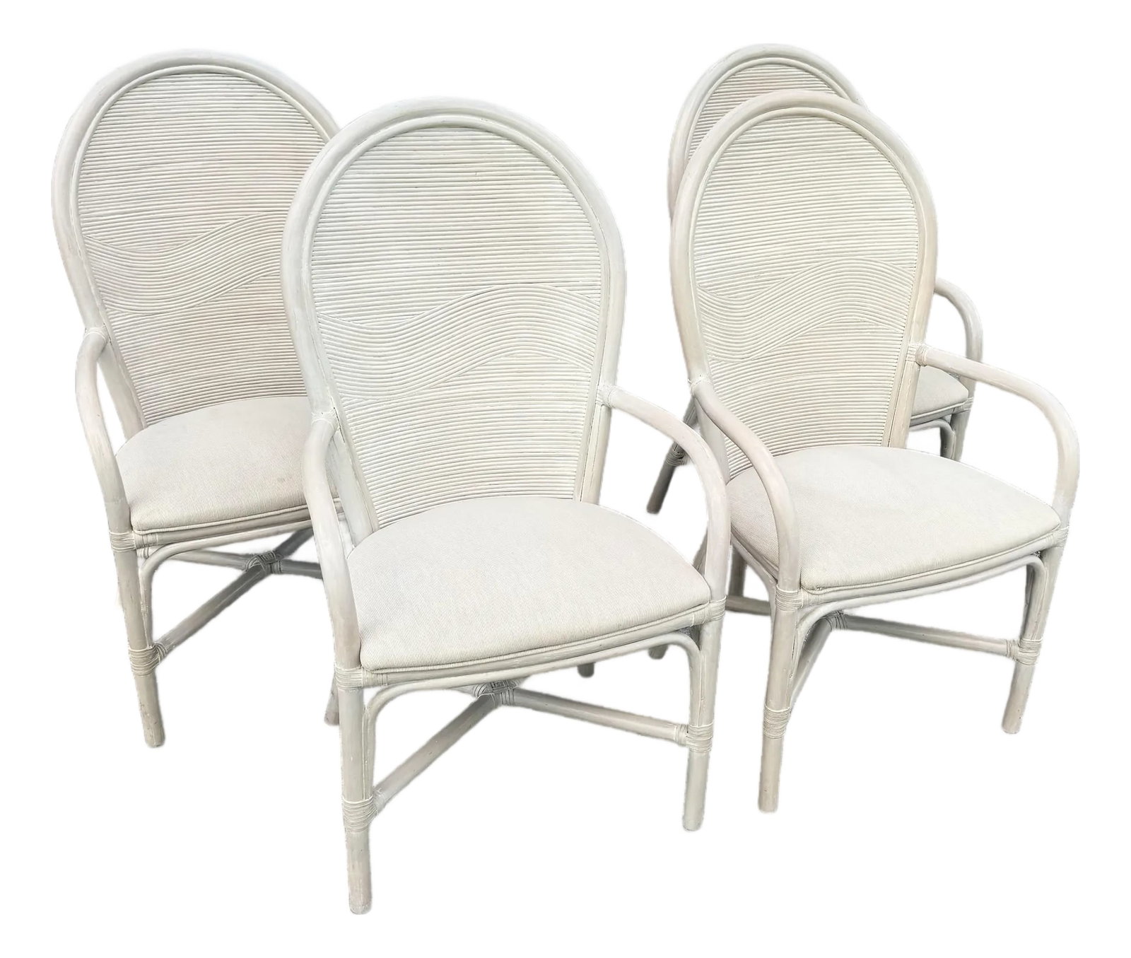 Boho Chic Wavy Pencil Reed and Rattan Dining Arm Chairs - Set of 4: Elegant boho chic dining arm chairs crafted in pencil reed and rattan, featuring softly arched backs with a subtle wave motif. The light, neutral finish highlights the organic texture, while