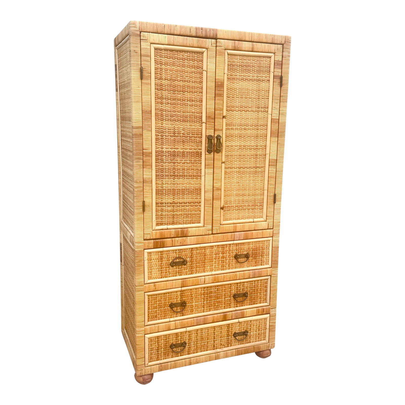 Boho Chic Wicker Wrapped Rattan Armoire: A beautifully crafted boho chic armoire that effortlessly blends coastal elegance with functional versatility. Expertly wrapped in warm-toned wicker and rattan, this vintage statement piece showcases 
