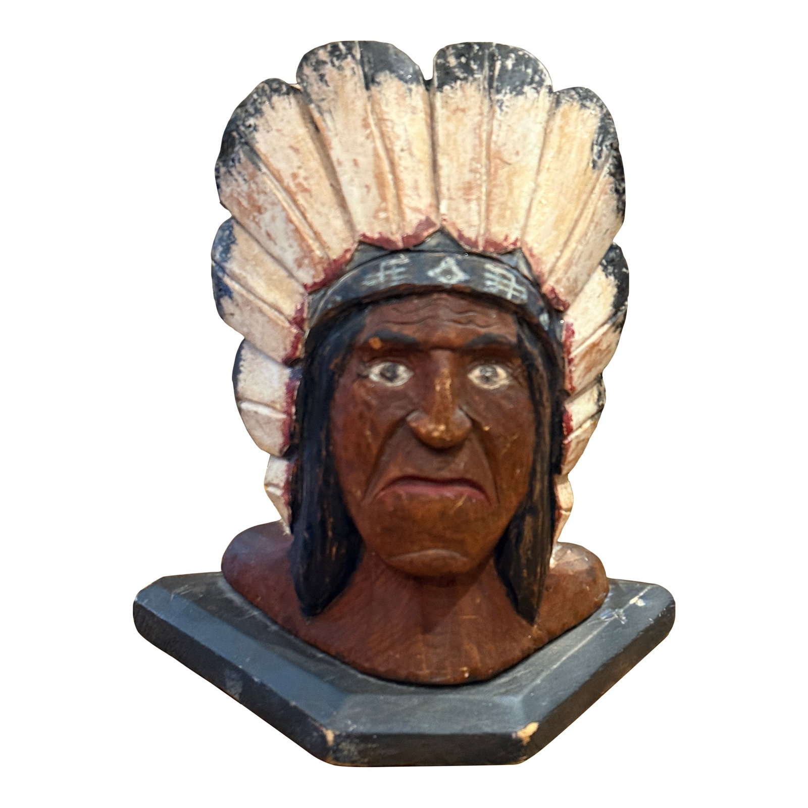 1920s Folk Art Carved Native Chief Doorstop Polychrome Painted Wooden Sculpture: Wonderful early folk art carved wooden bust depicting a Native chief wearing a traditional feathered headdress with aged polychrome painted decoration. This hand-carved piece has a strong primitive