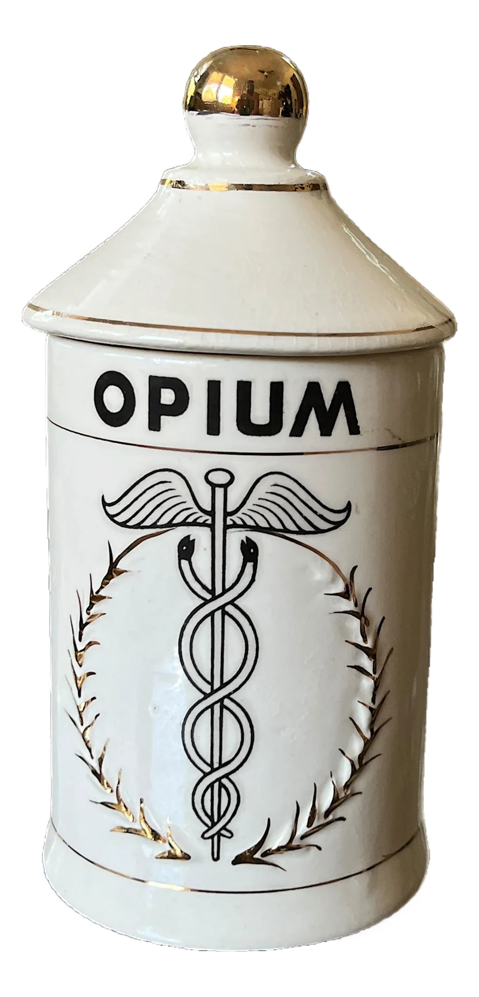 Mid-Century Handpainted Porcelain "Opium" Apothecary Canister in the Style of Piero Fornasetti M: A wonderfully eccentric mid-20th century porcelain apothecary canister marked "OPIUM," featuring a caduceus motif framed by hand-decorated gilt botanical detailing and topped with a sculptural gold fi