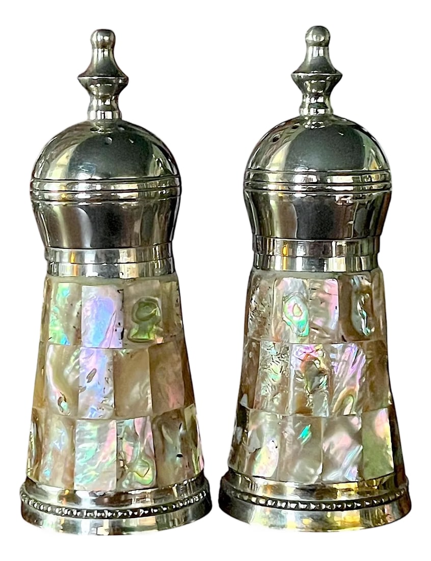 Vintage Abalone Shell & Stainless Steel Salt and Pepper Shakers in the Style of Los Castillo: Striking vintage salt and pepper shaker set clad in luminous abalone and mother-of-pearl mosaic with polished stainless steel tops and bases with plastic liners. The iridescent shell tiles shimmer wit