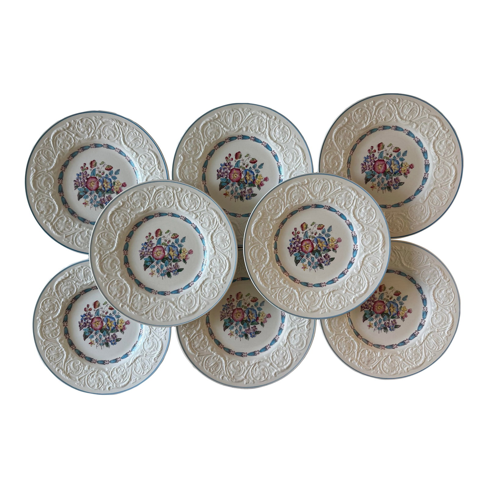 Set of 8 Wedgwood Salad Plates in the Morning Glory Pattern: Set of 8 beautiful Wedgwood 8.5" salad plates in the floral pattern "Morning Glory". Plates feature a center full of colorful flowers and an embossed floral pattern with a blue pinstripe around the ri