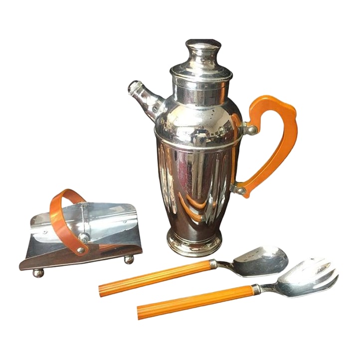 1930s Art Deco Chromium Cocktail Shaker Serving Set W/Butterscotch Bakelite Handles: This handsome Art Deco period cocktail set features a large chrome spouted shaker, a napkin holder and two utensils. The butterscotch Bakelite handles on all four pieces make it a unique ensemble, rea