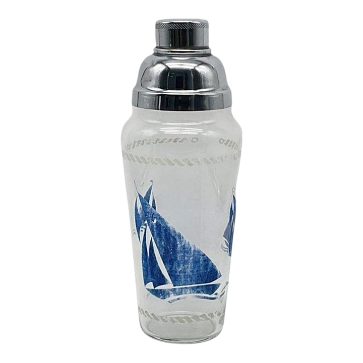 1930s Art Deco Clear Glass Cocktail Shaker With Blue Transferware Sailboat Design: This whimsical large Art Deco cobbler-style cocktail shaker features a blue sailboat pattern over a clear glass tapered body with a large shoulder and a two-piece aluminum dome top with a built-in str