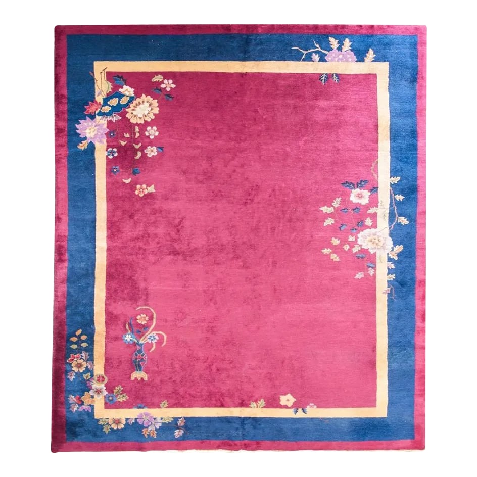 Early 20th Century Chinese Art Deco Rug: A wonderful early 20th century Chinese Art Deco rug with a cranberry field surrounded by a gold inner stripe, wide indigo central stripe, and a thin cranberry outer stripe. Peony and chrysanthemum clu