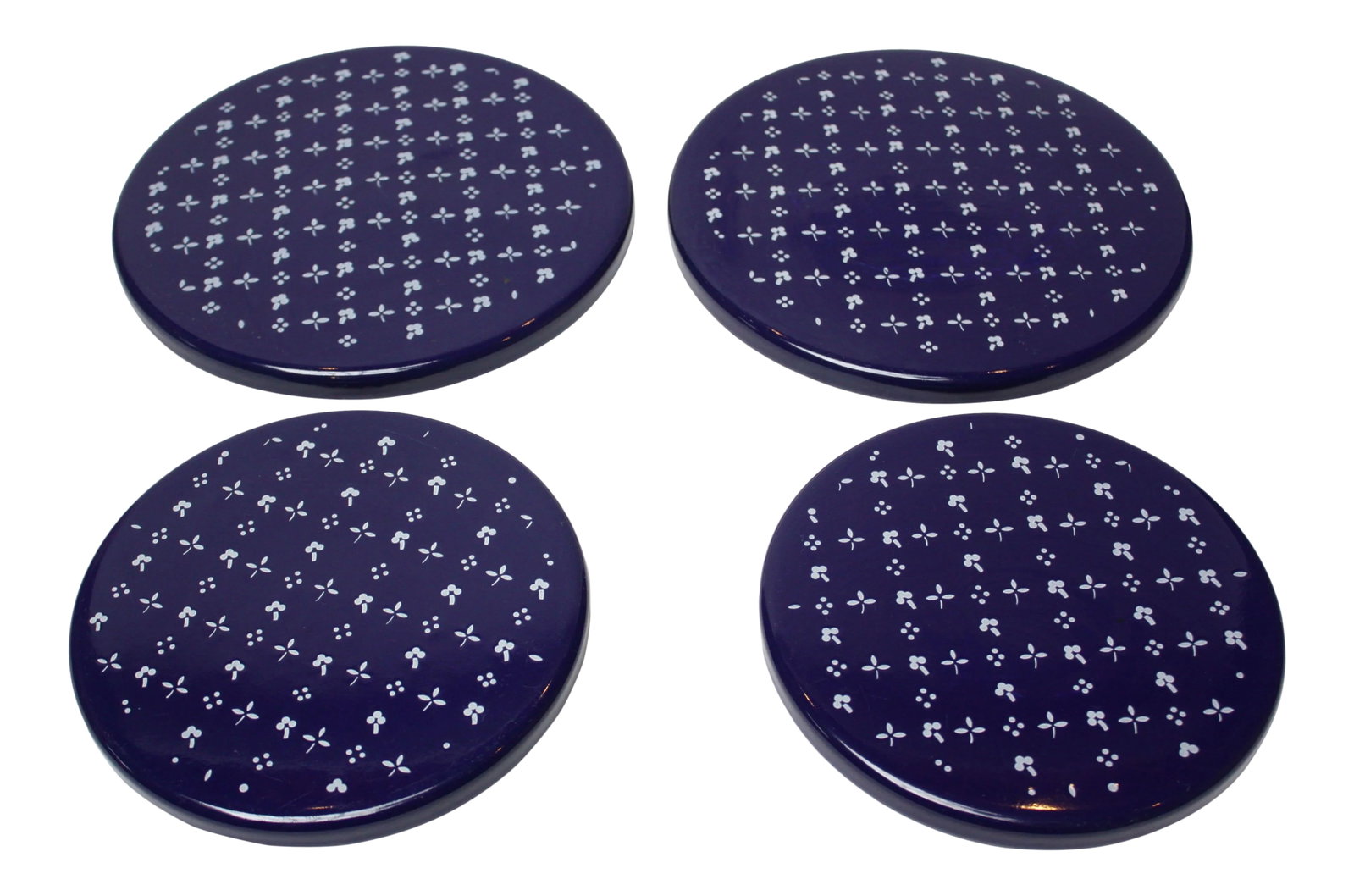 Set of Four Scandinavian Modern Indigo Enamel Trivets / Plates: Set of 4 (2 larger and 2 smaller) 1960s Scandinavian Enamel Plates / Small Serving Platters / Round Trivets in indigo with white clover detail. The larger two trivets measure-Diameter: 10" x H: .25",