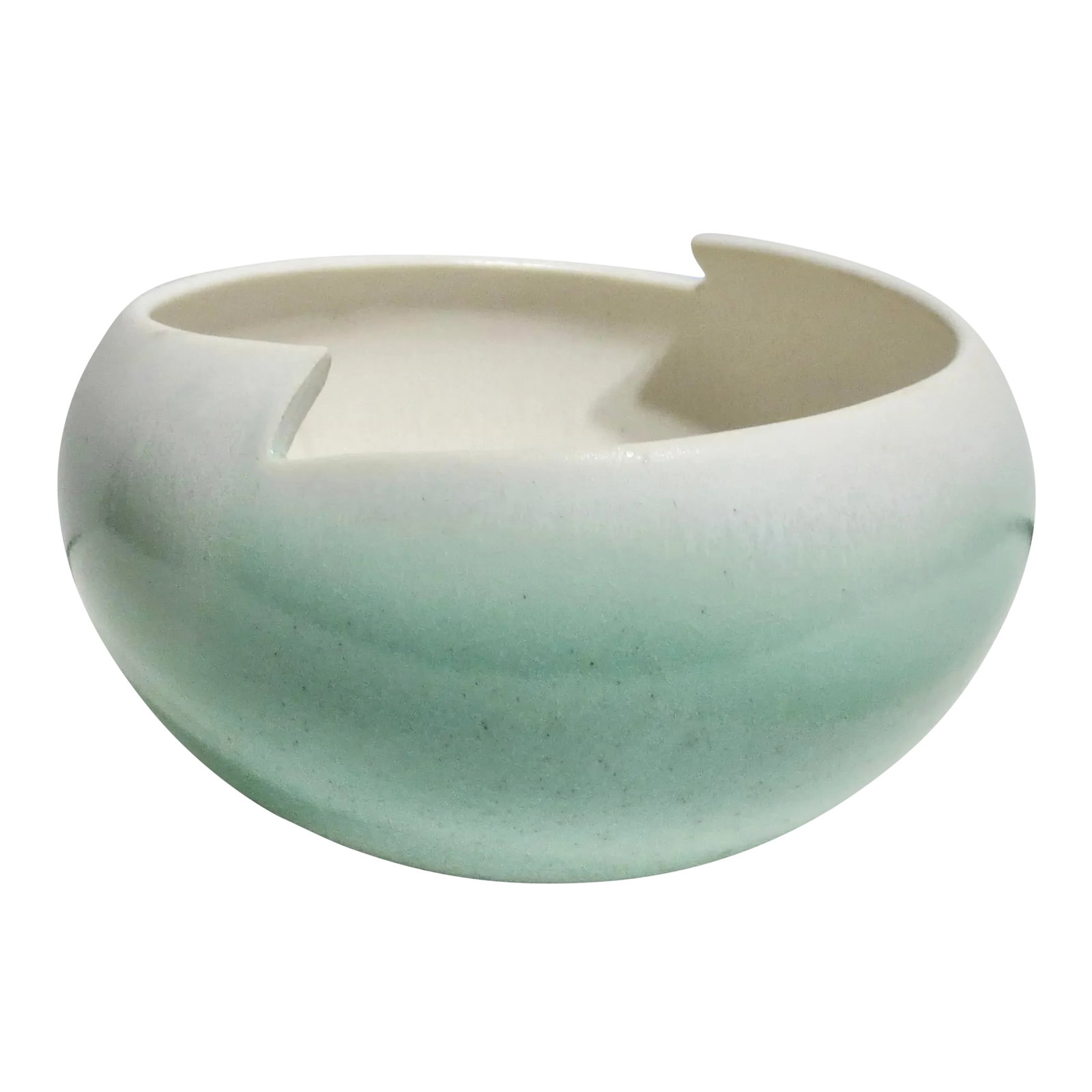 Salt-Glazed Porcelain Bowl Circa 80s: Beautiful globular-shaped bowl with modern asymmetrical sculpted rim. air-brushed shading of pale aqua to the outer sides. Salt glazes produce a slight orange-peel texture to the surface. Thin-formed 