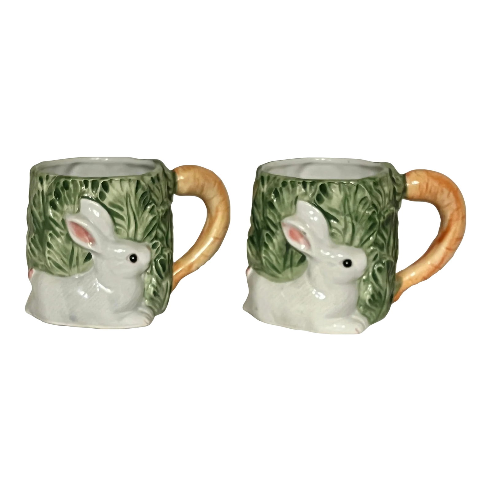 Ceramic Japan Rabbit in Carrot Patch Mug - a Pair: Vintage ceramic mugs depicting a rabbit in a field of leaves with orange carrot handle. Displays well with cabbageware and other green dinnerware. Each measures 5.5" w with handle x mug portion 3.5"