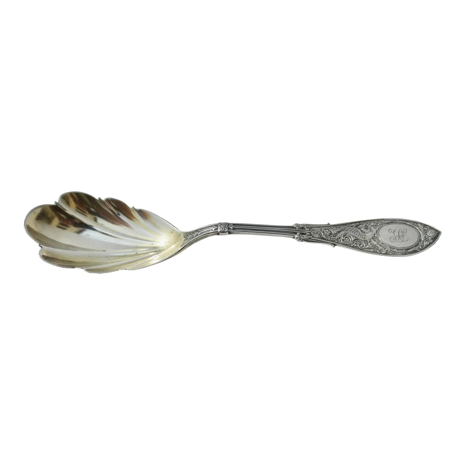 Sterling Silver Sugar Spoon by T. L. Shaw 1875: Sterling Silver Beaux-Arts Medival Revival Pattern. Griffins in elaborately knotted looping fields. Scalloped bowl for sugar. Heavily patterned across the handle on the front and back. Marked