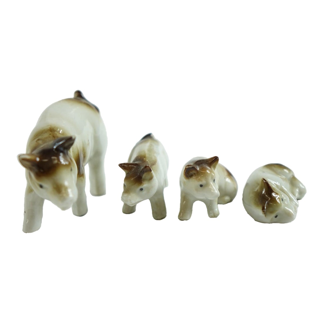 Mid 20th Century Porcelain European Pigs Figurines - Set of 4: Porcelain European Pigs Figurines – Set of 4 – 3ʺW × 2.75ʺD × 1.75ʺH This delightful set of four European porcelain pig figurines brings a touch of countryside