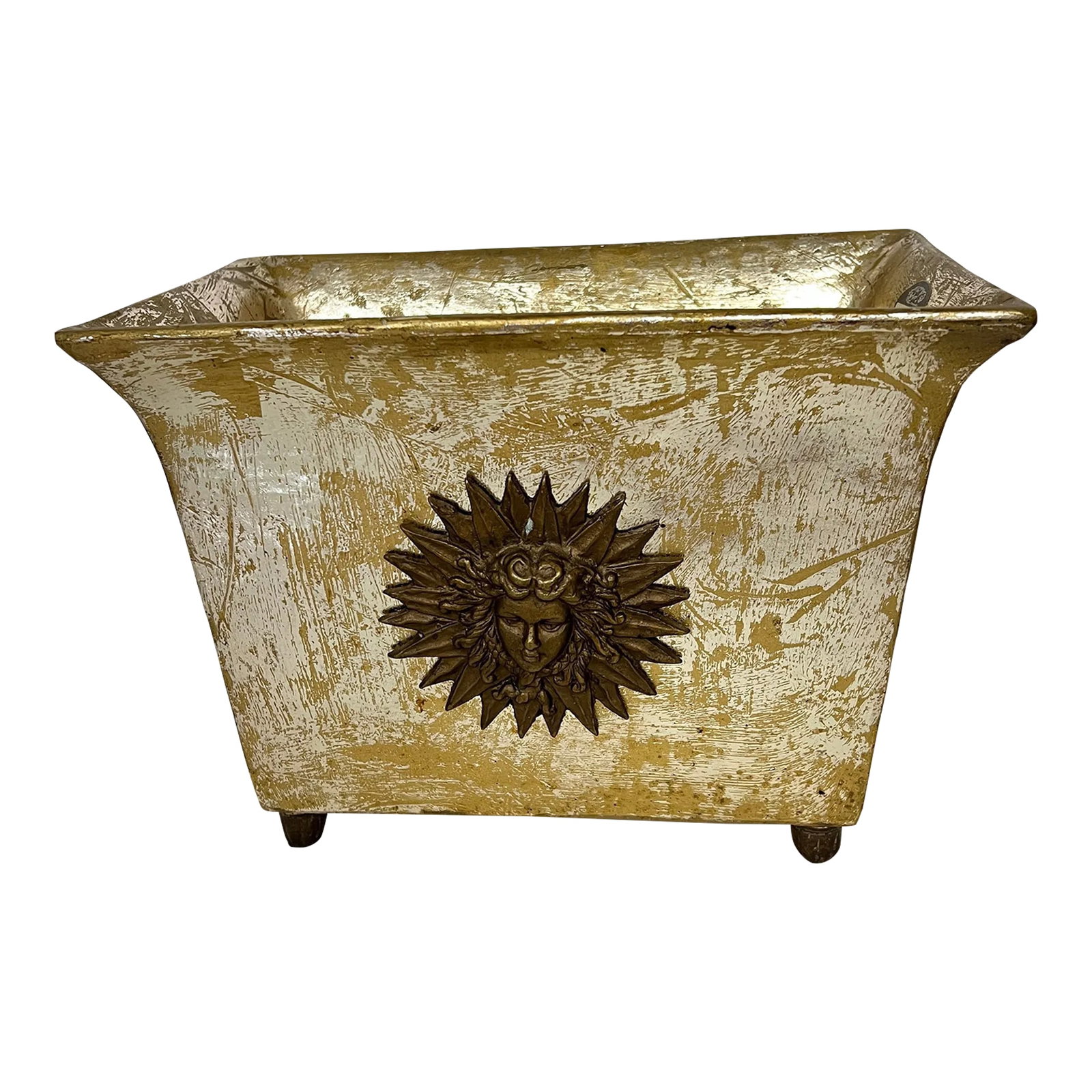 Footed Silver / Gold Wash Planter Adorned With Sun King Medallion: Footed planter with gold over silver wash finish. And adorned with a bronzed metal medallion of the Sun King on each side. Measures 11.5" w x 7.5" d x 8.5" h. Made from composite material. Medallion a