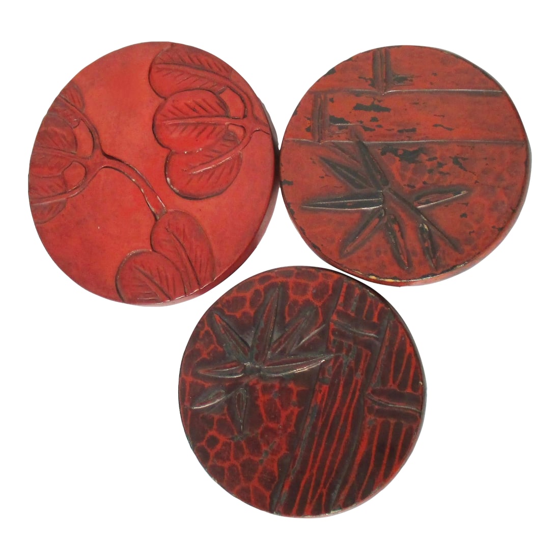 Kamakura-Bori Japanese Lacquer Trivets- Set of 3: Three trivets in Kamakura -Bori lacquer, a method used to layer lacquer and rub away to polish the surface. The Carved surface is prepared in wooden disks, and many layers of lacquer are built up to