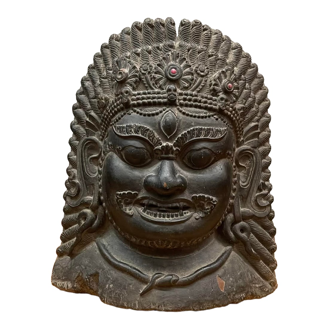 Large Nepalese Lacquered Wood Bhairab Mask Sculpture: A bold and intricately detailed depiction of Bhairab, the fierce manifestation of the Hindu god Shiva, venerated in both Hindu and Buddhist traditions of Nepal. Likely crafted in the mid-20th