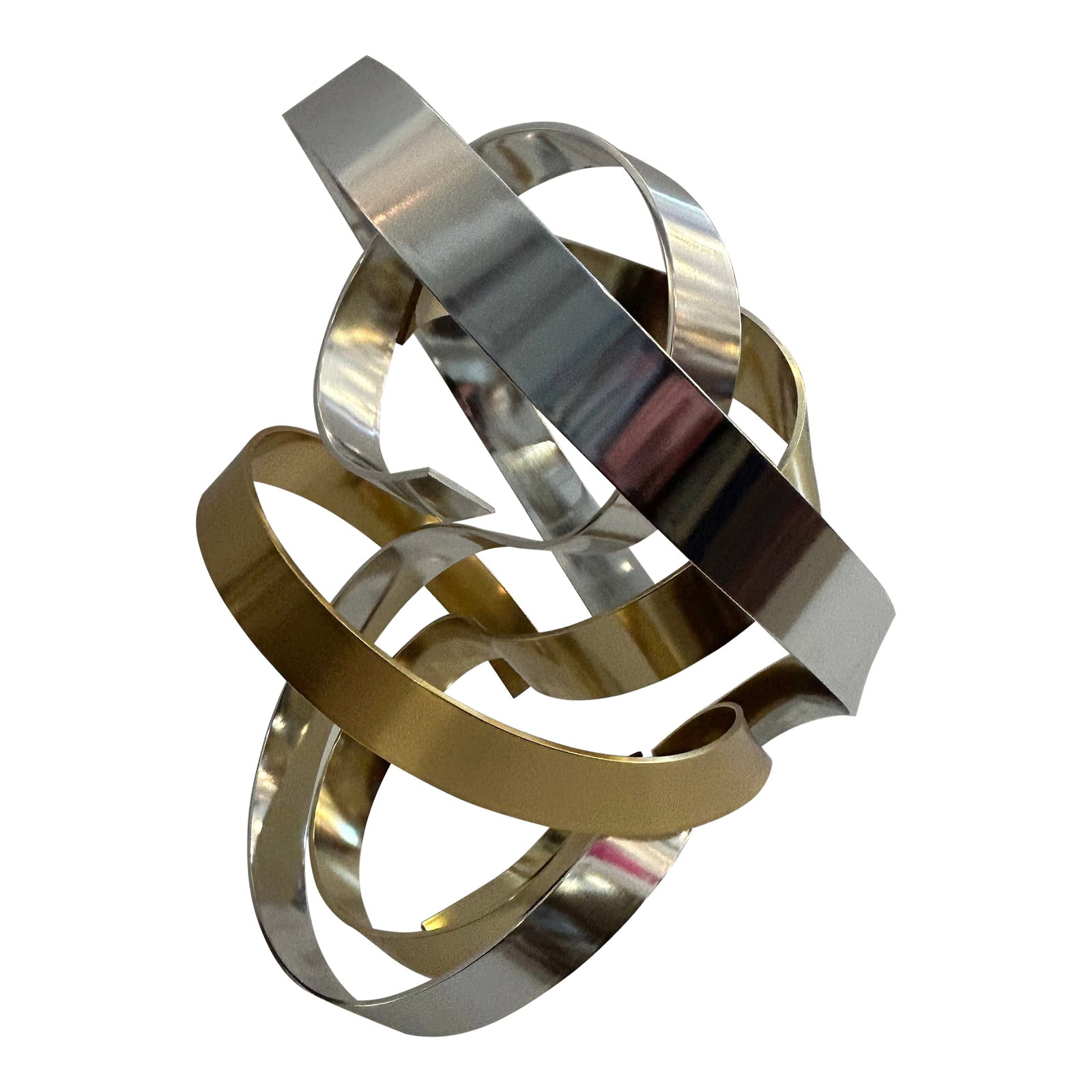 Chrome and Brass Ribbon Motif Abstract Tabletop Sculpture: Striking abstract metal table top sculpture by Chapel Hill artist Dan Murphy, signed on bottom. The mixed metal gold and silver creation conjures up layers of ribbons floating on a 6.5 x 6 lucite base