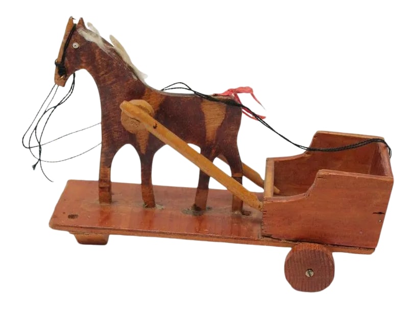 Hand-Carved Folk Art Horse Pulled Cart: Ca. 1930s/1940s primitive carved wooden horse pulled cart with string reins, a cotton mane, and inset glass eyes. Crude example of a common Folk Art subject with good age / patina present, as shown