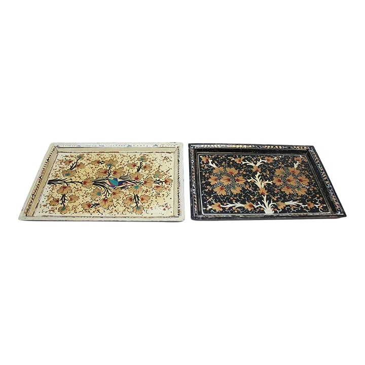 Set of Two Vintage Kashmiri Hand-Painted "Nature-Study" Decorative Trays: Set of two hand-painted/decorated trays (ca. 1970s, India). The cream and gold tray depicts a bird with pops of red and blue amid flowers and leaves, while the black tray has corresponding gold foliag