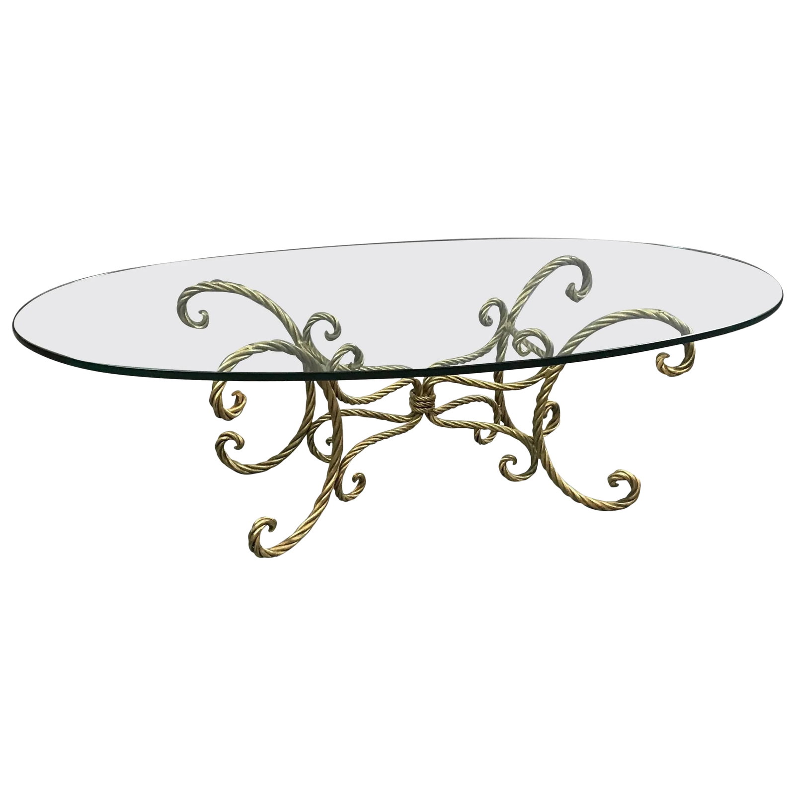 1960s Hollywood Regency Gilt Braided Rope and Oval Glass Coffee Table: Italian, midcentury, Hollywood Regency, coffee or cocktail table features a gilt iron, braided, rope motif base with a thick oval glass top. Condition: Alterations: Restored Imperfections: Some Imperf