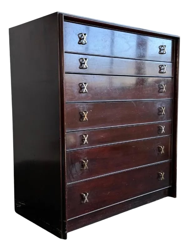 1950s High-Boy Dresser With Nickel X-Shaped Pulls by Paul Frankl for Johnson Furniture: This vintage gem is designed by the iconic and prolific Paul Frankl for Johnson Furniture Co. retailed by John Stuart in the heart of New York City, circa 1950s. This highboy dresser is made of dark l