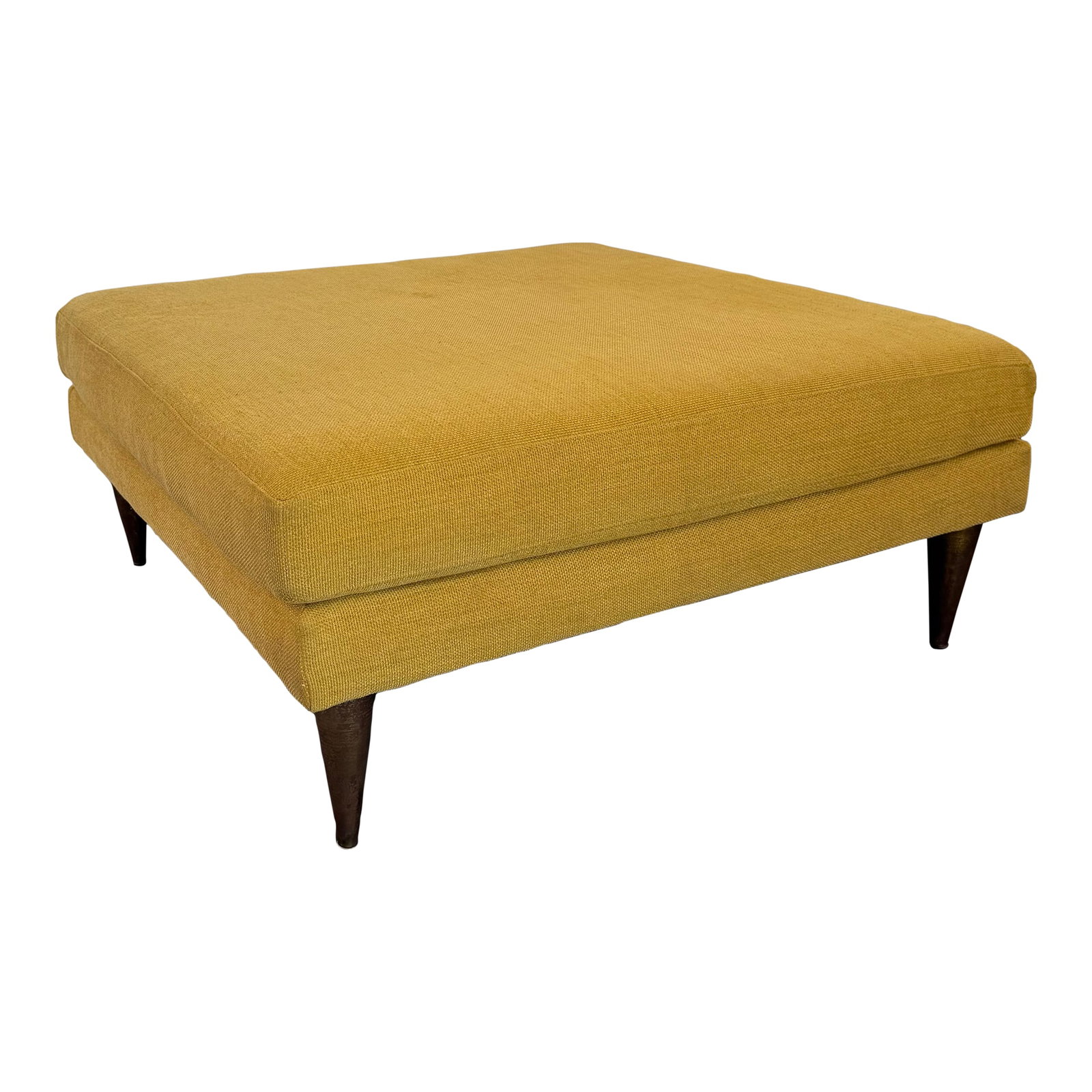 Mid-Century Modern Style Oversized Square Upholstered Ottoman: This oversized Mid-Century Modern style square ottoman features a double cushion design upholstered in a mustard-yellow tweed. The generously scaled, low-profile cushion is anchored by four sharply