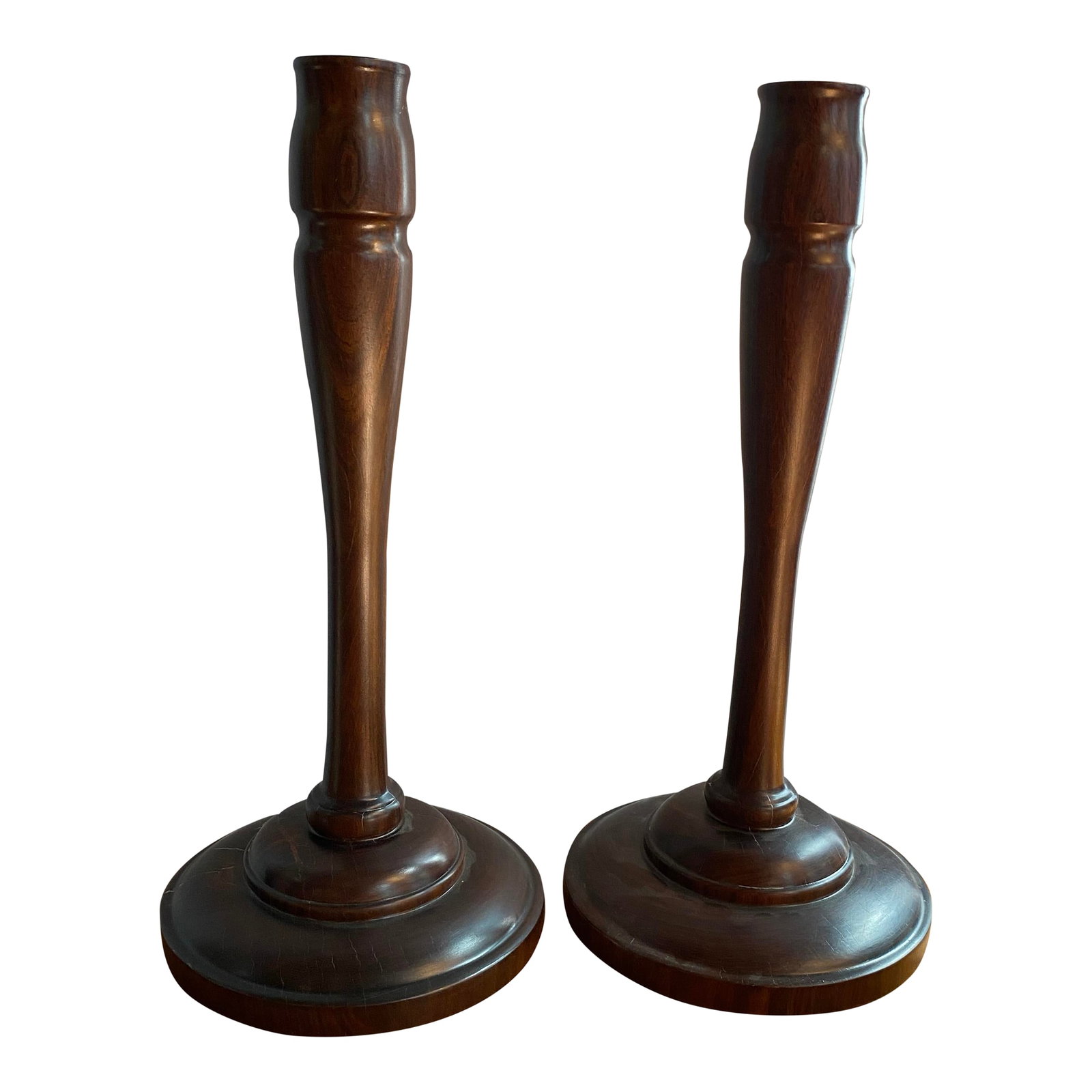 20th C. Pair of Mid-Century Modern Tall Turned Rosewood Candle Holders: Crafted from solid rosewood, this pair of mid-century modern candle holders features an elegant, elongated turned wood silhouette. The rich, deep rosewood showcases a beautifully defined grain pattern