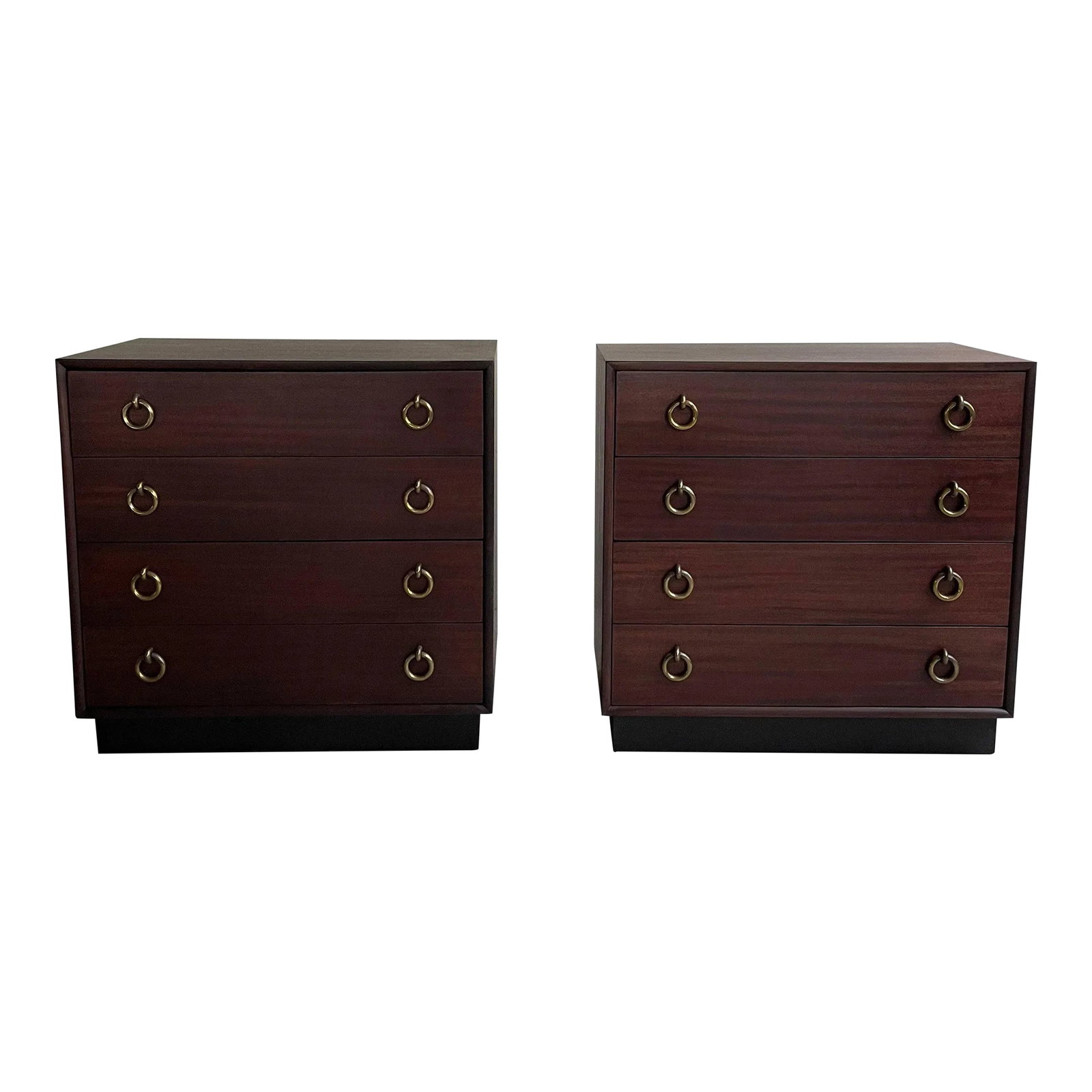 Pair of Hollywood Regency Mahogany Dressers Attributed to Gilbert Rohde: This pair of matched, Hollywood Regency, mahogany, five drawer dressers are attributed to Gilbert Rohde circa the 1940s. The dressers feature outstanding brass ring pulls that stand out against the da