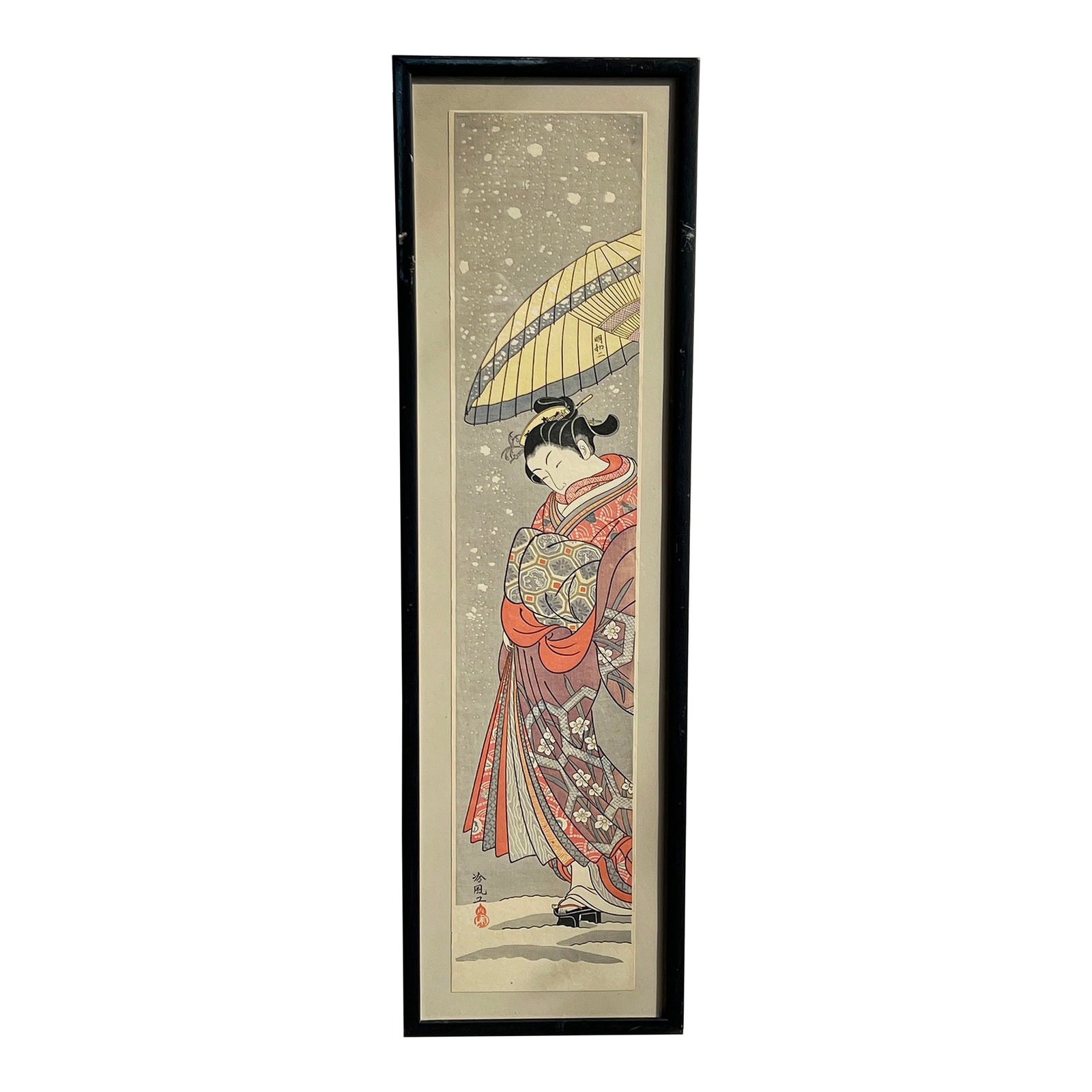Vintage Japanese Woodblock Print 'Courtesan on Parade in Falling Snow' by Suzuki Harunobu: This elegant woodblock print captures a courtesan gracefully walking in the snow, wrapped in a richly patterned kimono with intricate floral and geometric designs. Holding a delicate yellow parasol,