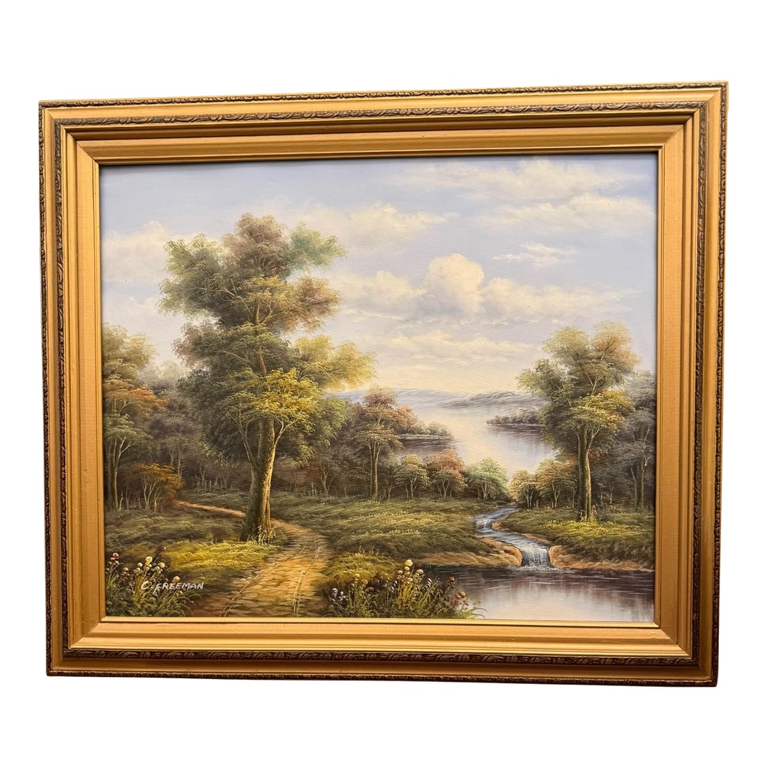 Mid 20th Century C. Freeman Landscape Waterfall Oil Painting: Quick Hits: Mid-century signed oil painting by landscape artist C. Freeman Romantic waterfall scene framed by trees, mountains, and winding paths Original carved wood frame with golden gilt finish