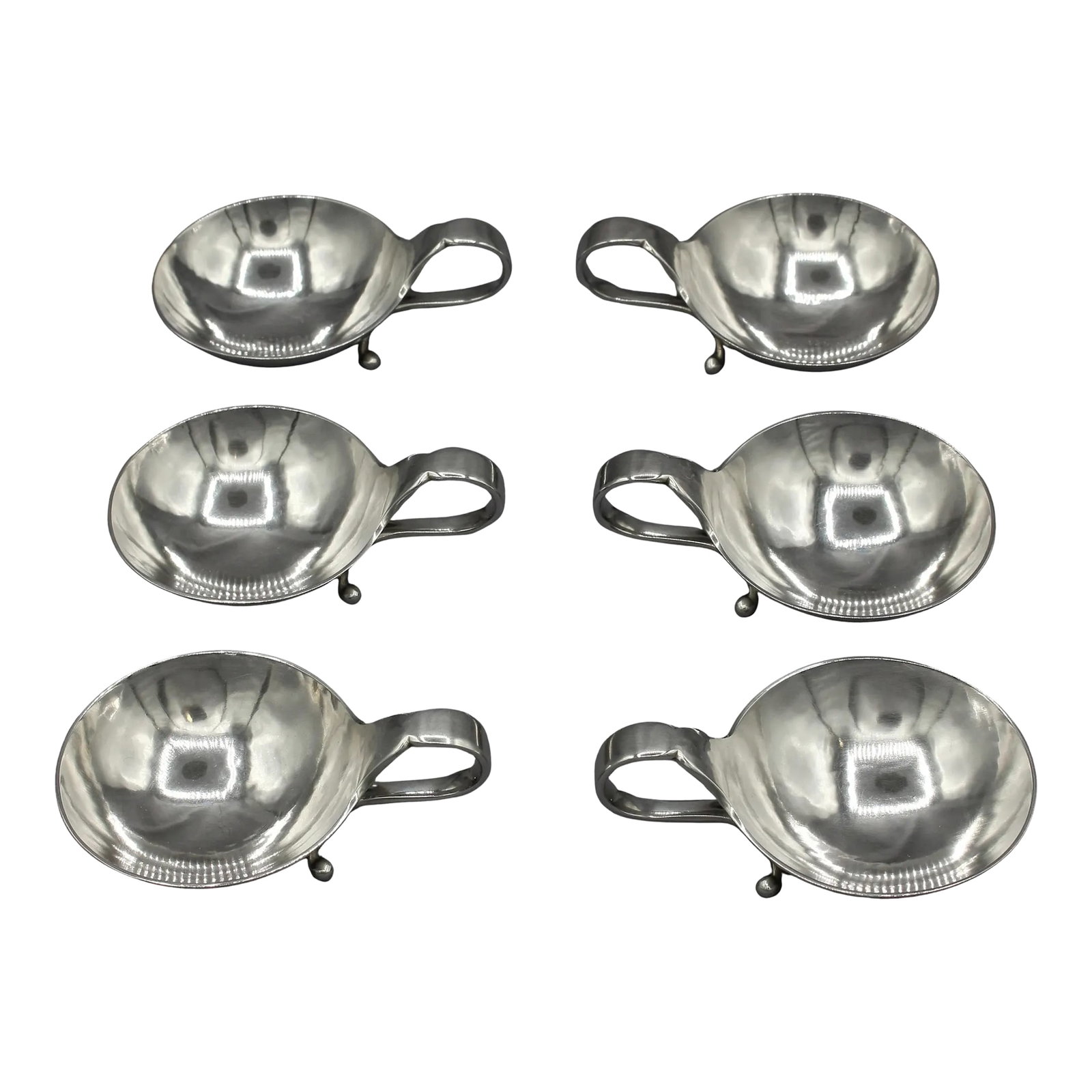 1933-1944 Set of 6 Sterling Silver Salt Dips by Georg Jensen: 1933-1944 set of 6 sterling silver salt dips by Georg Jensen. A 1935 wedding present. Hand wrought; shaped, curved handle to 2 scrolled feet. Pattern #110. 5.75 troy oz. 2 7/8" x 2" 1 1/8" h.
