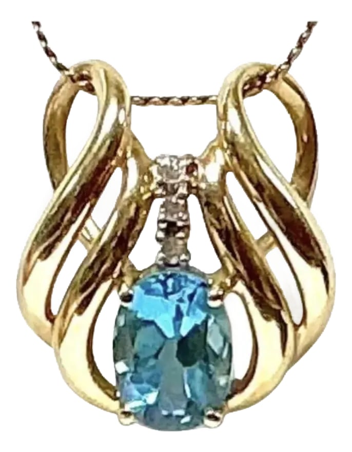 14kt Yellow Gold Blue Topaz With Diamond Pendant: Vintage 14K Yellow Gold Blue Topaz With Diamonds Pendant. Total weight is 2.54 grams. Pendant features a captivating oval-cut stone. Blue Topaz stone is approximately 8 x 5.5mm or approximately 1