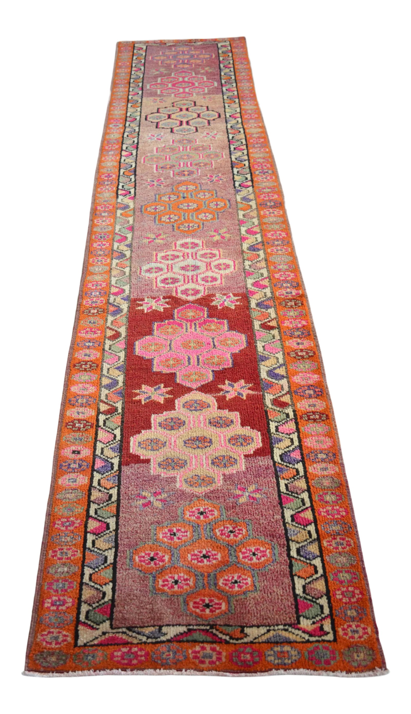1970s Hand Knotted Pink and Orange Runner: Offered is a gorgeous Kurdish runner rug, made in Anatolia approximately 50-60 years ago. The beautiful wool on cotton pile features multicolored geometric patterns on a wavy multicolored background.