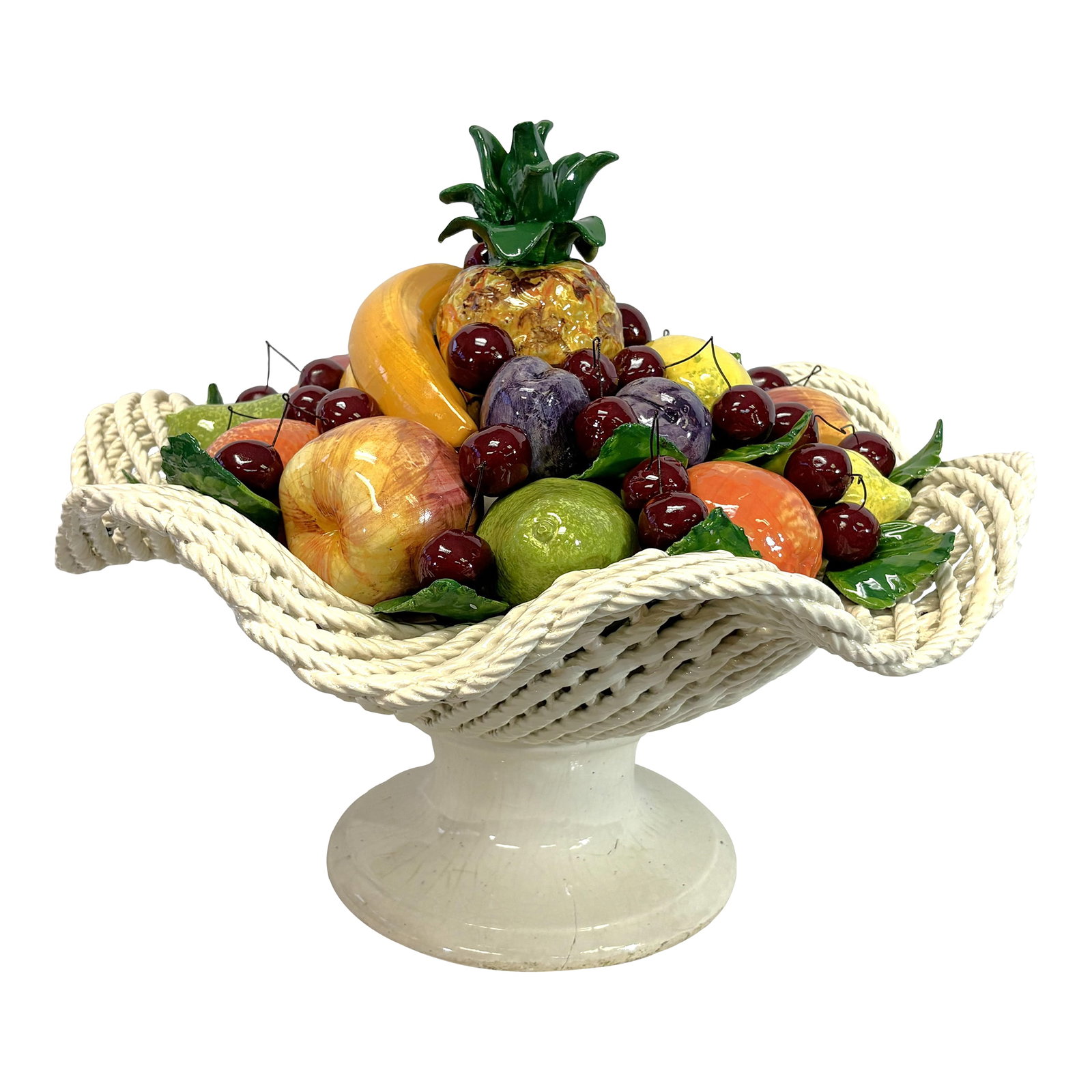 Vintage Large Scale Colorful Majolica Fruit Pedestal Centerpiece: Pretty large scale majolica fruit centerpiece from the mid 20th century. It is made of ceramic in the Italian majolica technique with life size colorful fruits overflowing from a woven pedestal dish. 