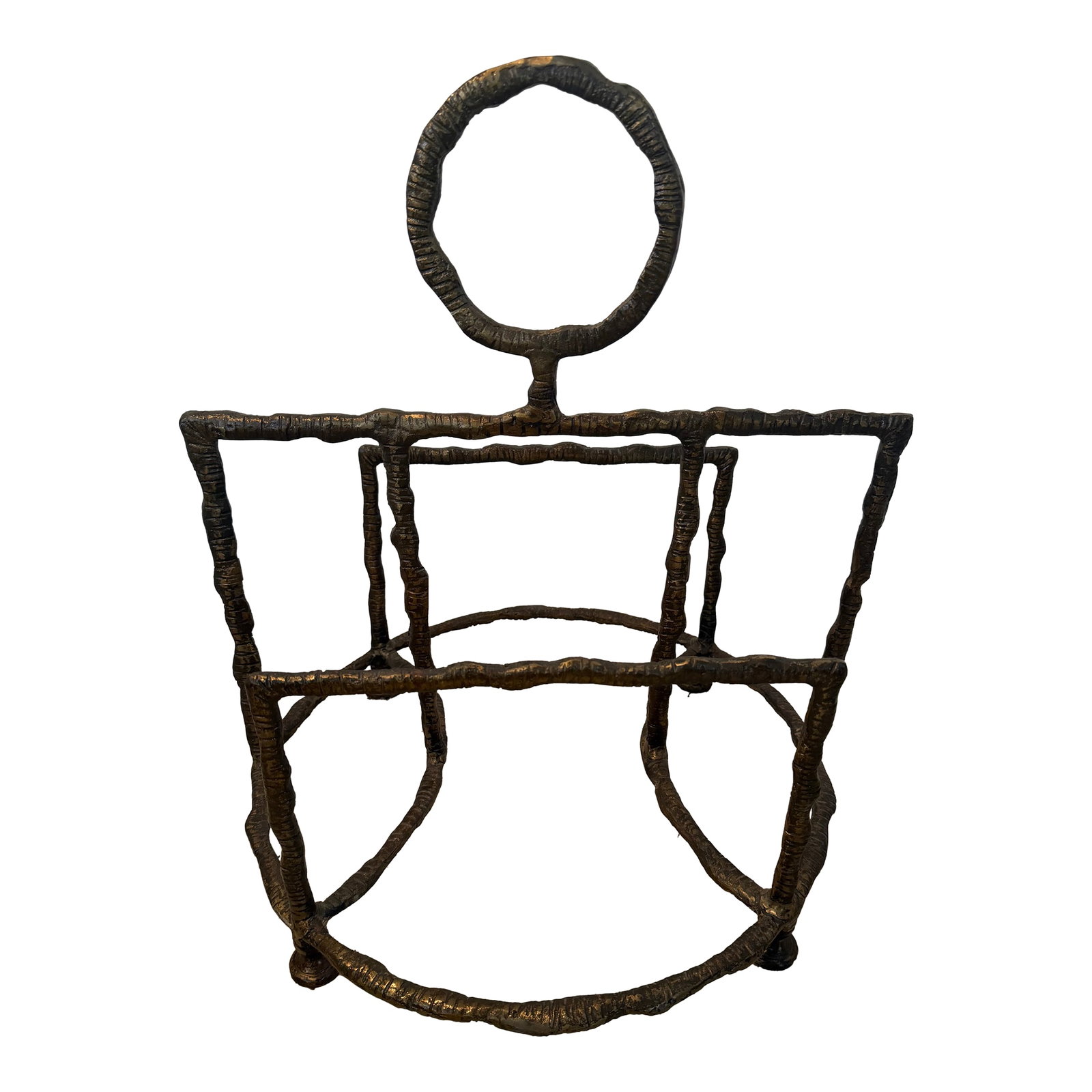 Giacometti-Style Hammered Iron Sithon Magazine Holder by Uttermost: Thick cast iron, featuring a crude, organic shape, with a beaten texture surface, hand finished in a plated antique brass and a durable overscaled ring. In excellent vintage condition. 18 W X 21 H X