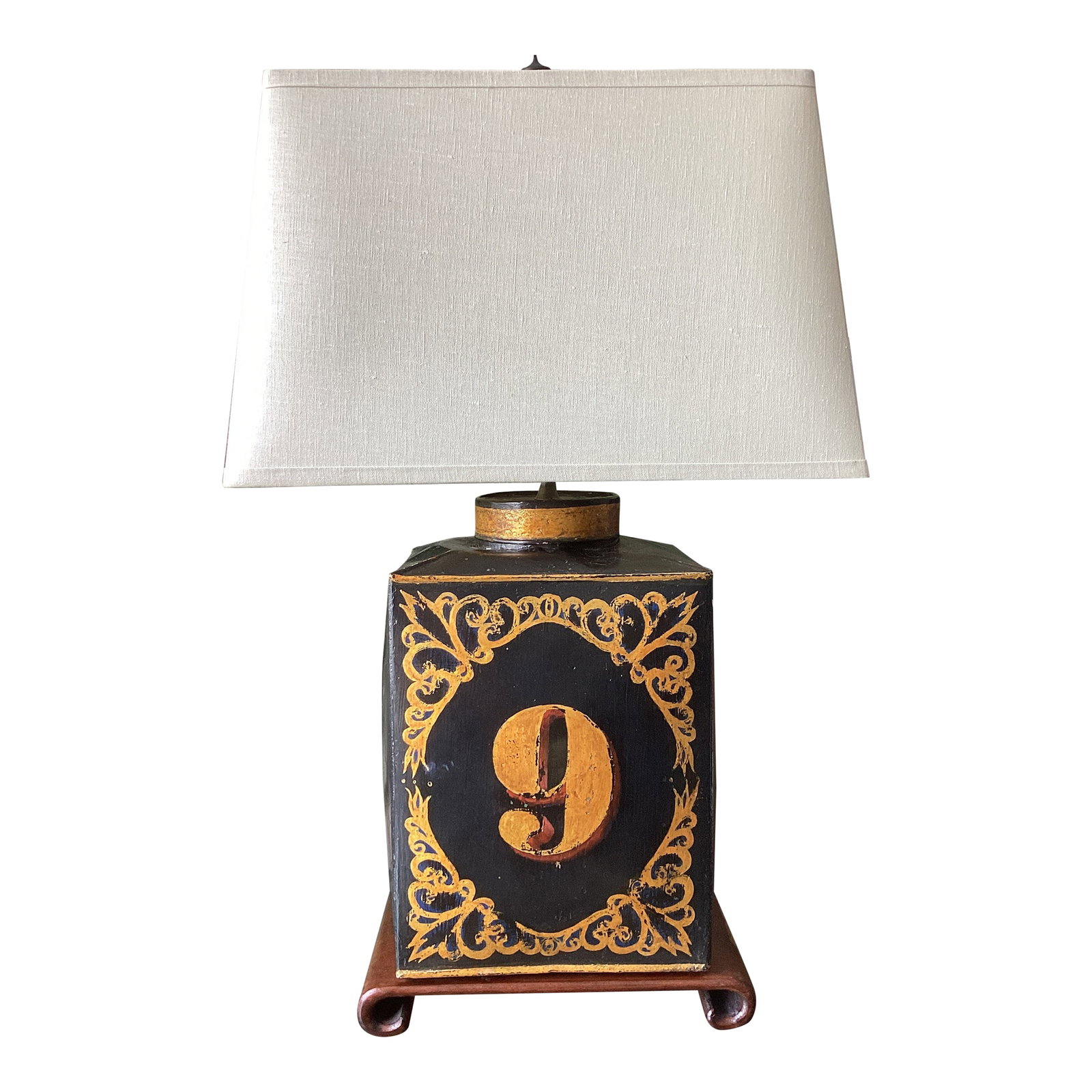 Vintage Tea Tin Folk Art "No. 9" Tole-Style Black & Gilt Table Lamp: Charming vintage folk art table lamp featuring a hand-painted "No. 9" framed by ornate gilt scrollwork on a brown scroll base. The distressed finish gives it a collected, old-world tavern or shop