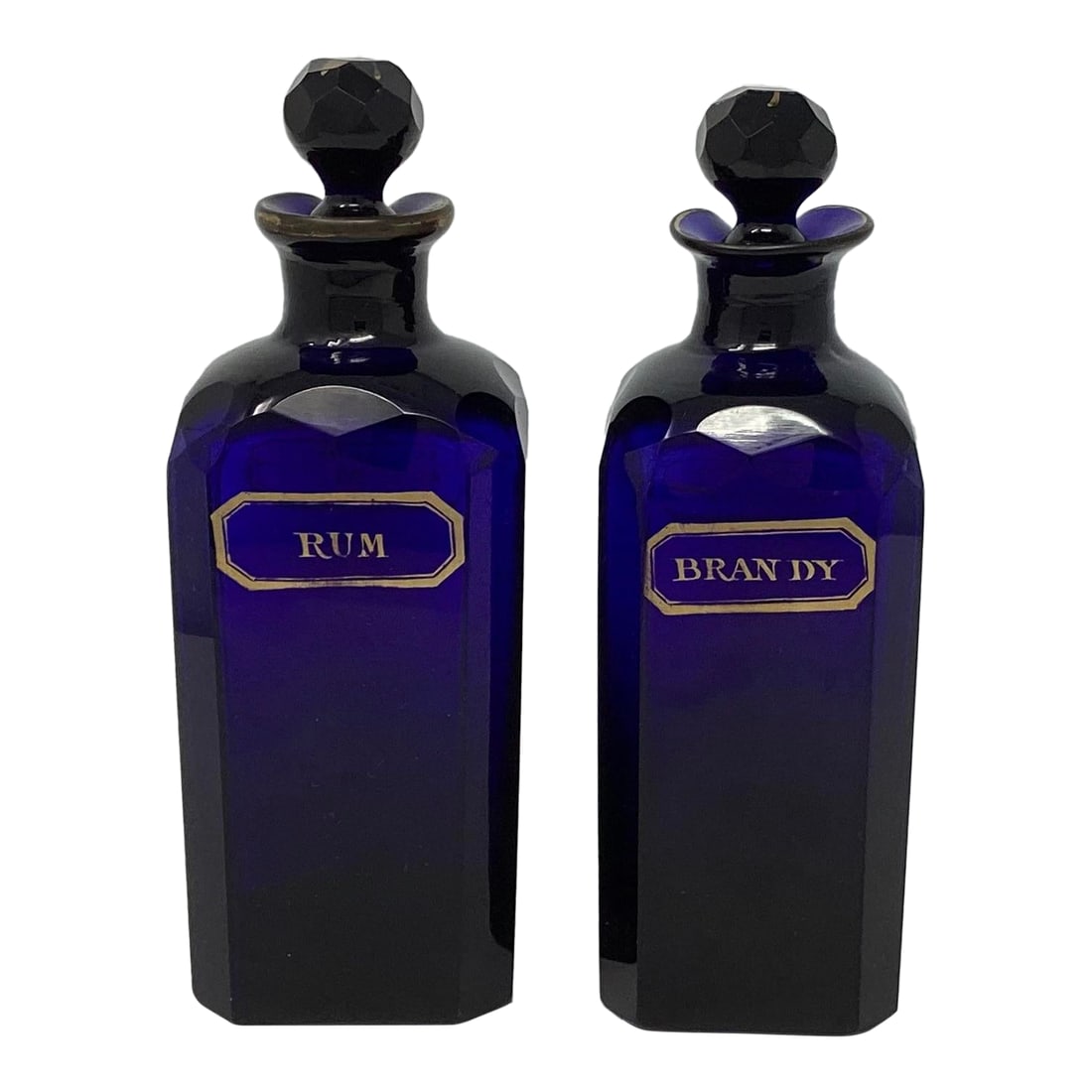 Pair of Mid 19th Century Bristol Blue Decanters With Gilt Decorations: These Bristol Blue Decanters are Rum and Brandy on the front. The backs have gilt grape cluster decoration. They are 3" square with canted corners. The top of each stopper also has gilt decorations.