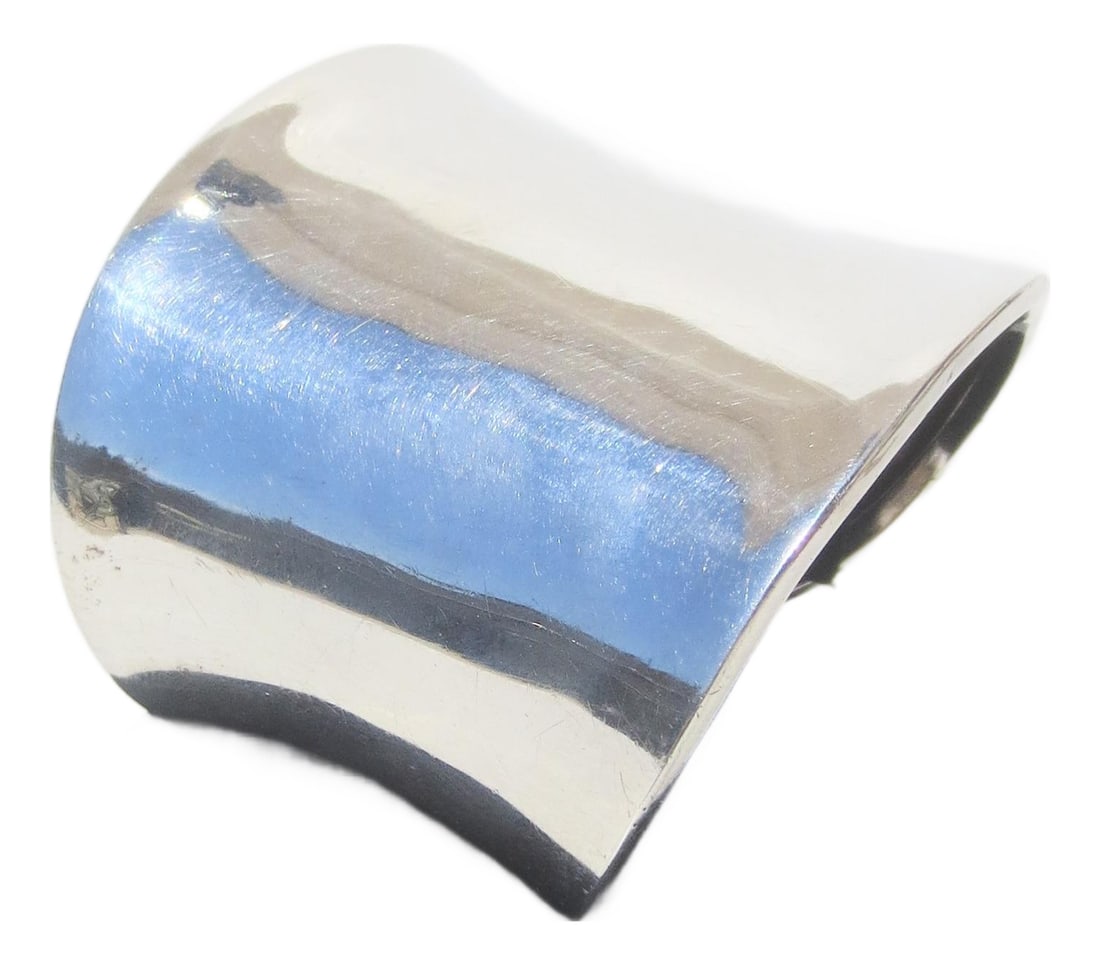Sterling Silver Modernist Cuff: Modernist Sterling silver cuff marked 925 TD-25 Mexico. Mirror gloss measures 6.5 on gauge. The weight is 40 Dwt. The width is 2.4" and across the opening is 2.5". circa 80s. INV SFB 40 Condition: