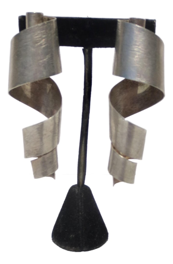 Brutalist Silver Metal Clip-on Earrings: Large metal, curled metal clip-on earrings. Brushed silver-plated brass, Large and striking statements. The measurements are 3.25" tall and 1.2" by 1" overall. No marks are seen. Likely OTILYAS. model