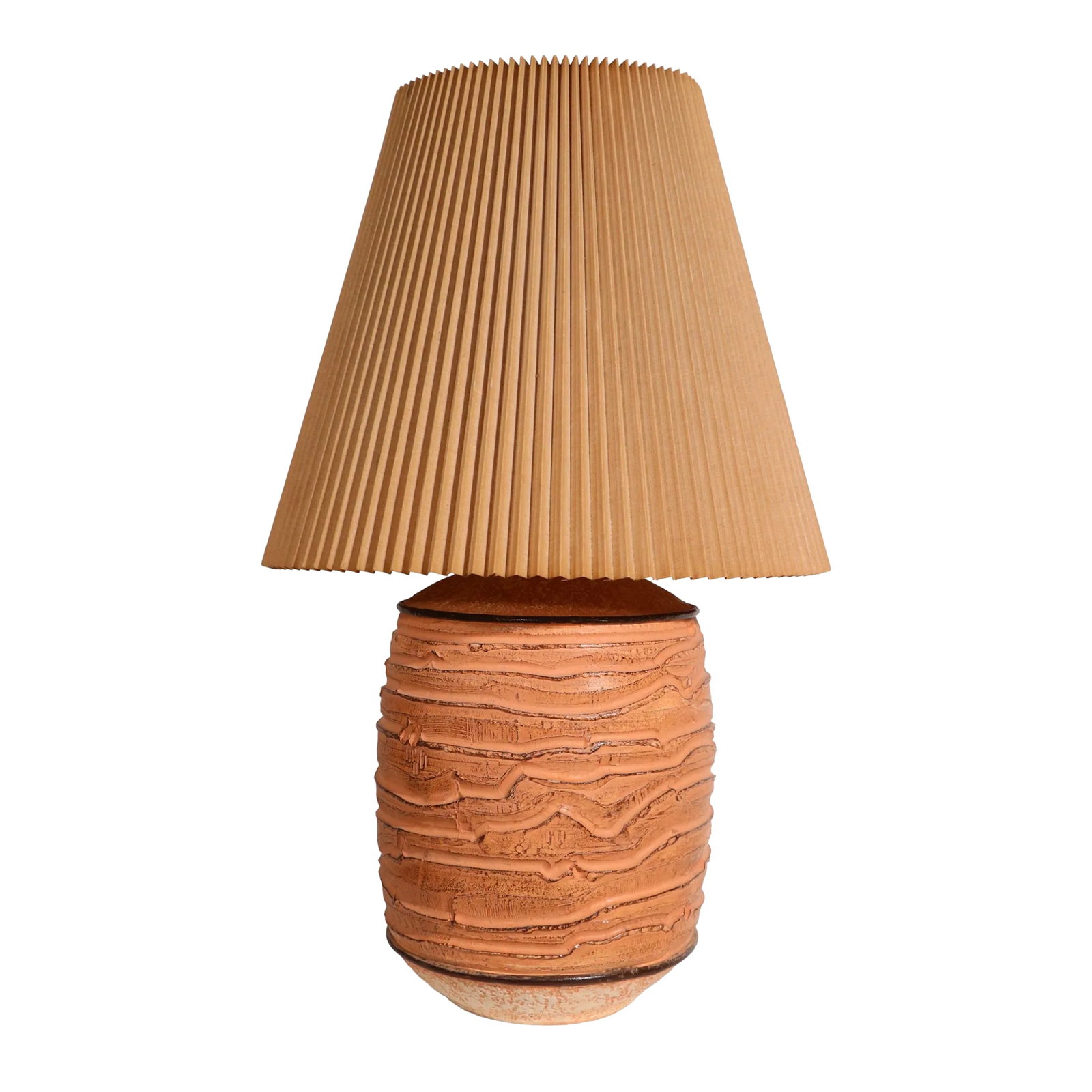 Cast Plaster Table Lamp With Original Pleated Shade by Casual Lamps of California C. 1981: Chic cast plaster oversized table lamp, with its original conical pleated shade. The lamp features a deeply textured surface, in muted shades of orange, it is marked "Casual Lamps 1981". The lamp is