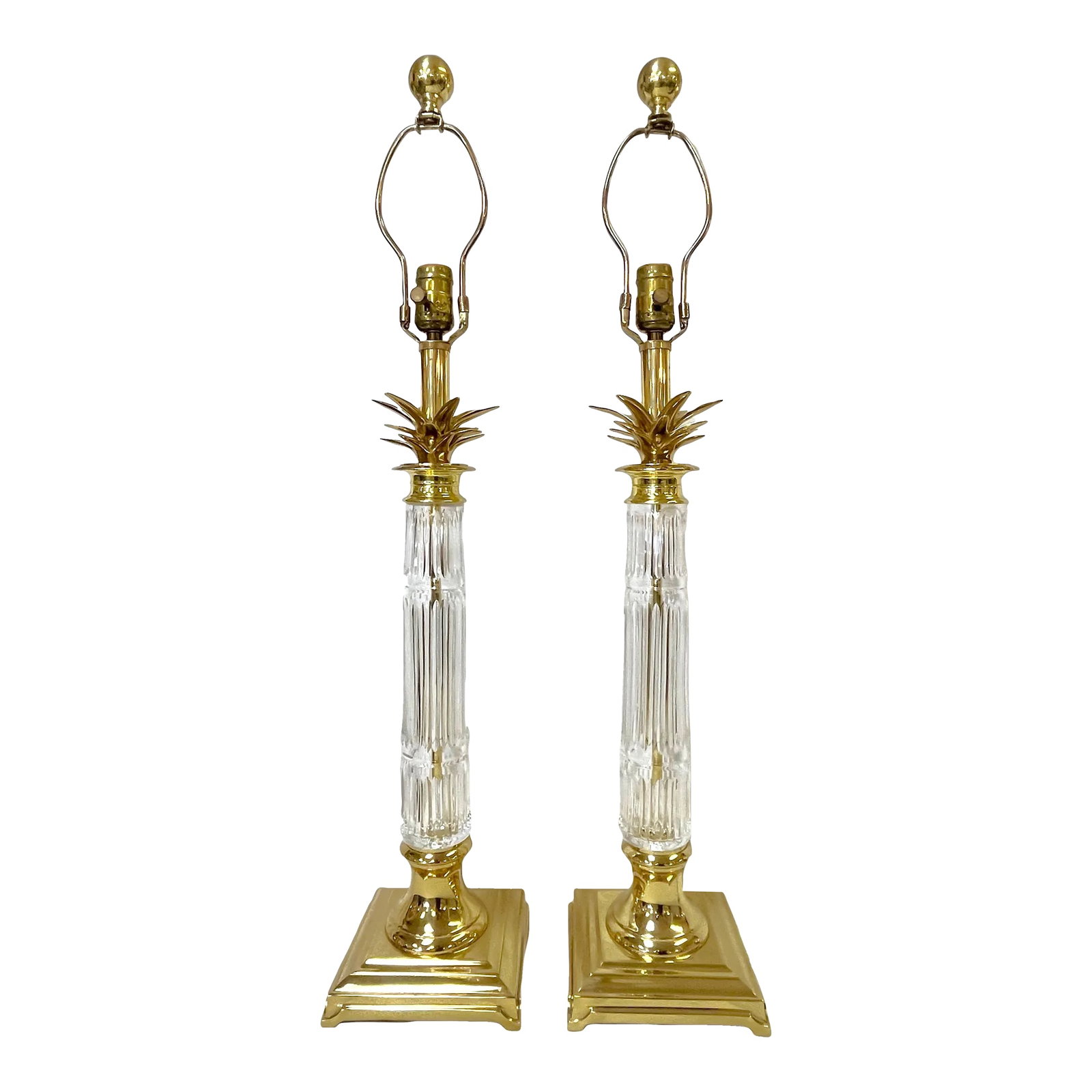 Vintage Hollywood Regency Brass and Cut Glass Candlestick Buffet Lamps- a Pair: Classic pair of Hollywood Regency style candlestick buffet lamps. They have an elegant tall center column made of fluted glass in the style of Waterford Crystal. Each is mounted on a beveled four