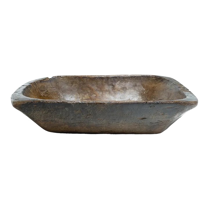 Provincial Chinese Farm Tray, C. 1900: This wooden farm tray from northern China charms with its rustic finish and asymmetrical form. Hand-carved from a single block of wood, the large tray is truly one-of-a-kind, shaped with a deep basin