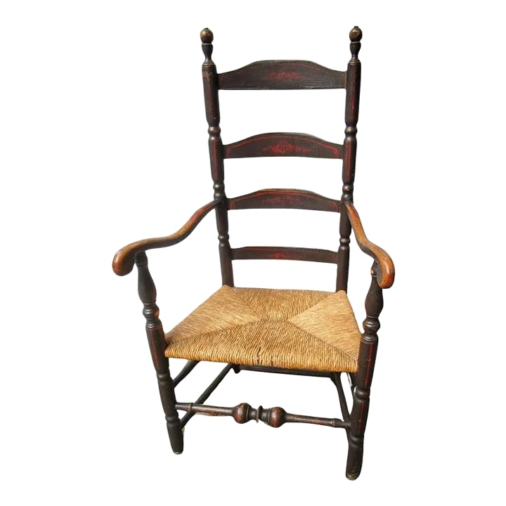 18thc American Stenciled Ladderback Chair With Rush Seat and Original Finish: This rare 18th century painted oak and stenciled New England ladderback chair features a heavily defined lower stretcher, graceful arms terminating in round knobs, and three slats in the back with tur