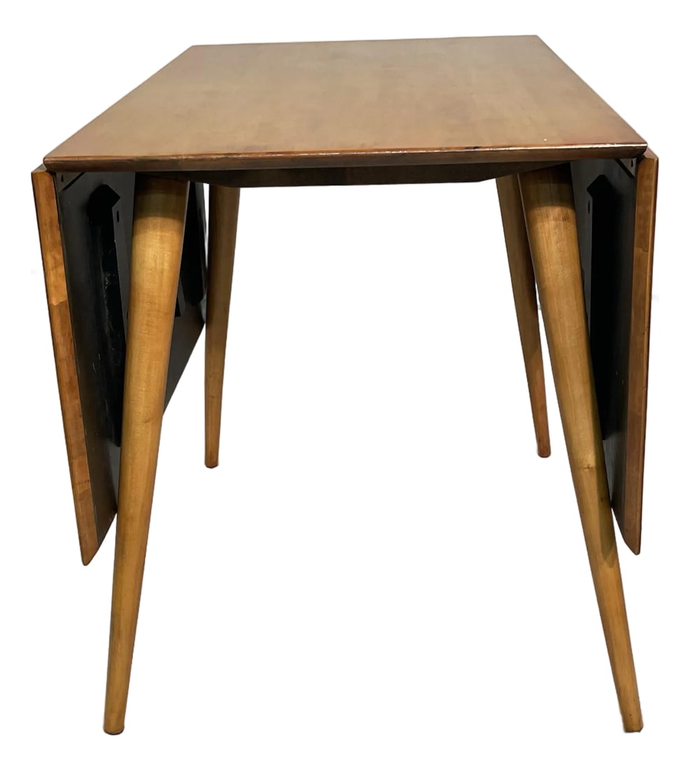 Paul McCobb Attributed Midcentury Maple Drop Leaf Table: Offered is a mid century modern maple dining table attributed to designer Paul McCobb and his Planner Group. It has undergone at least one previous restoration and its original label/brand on the