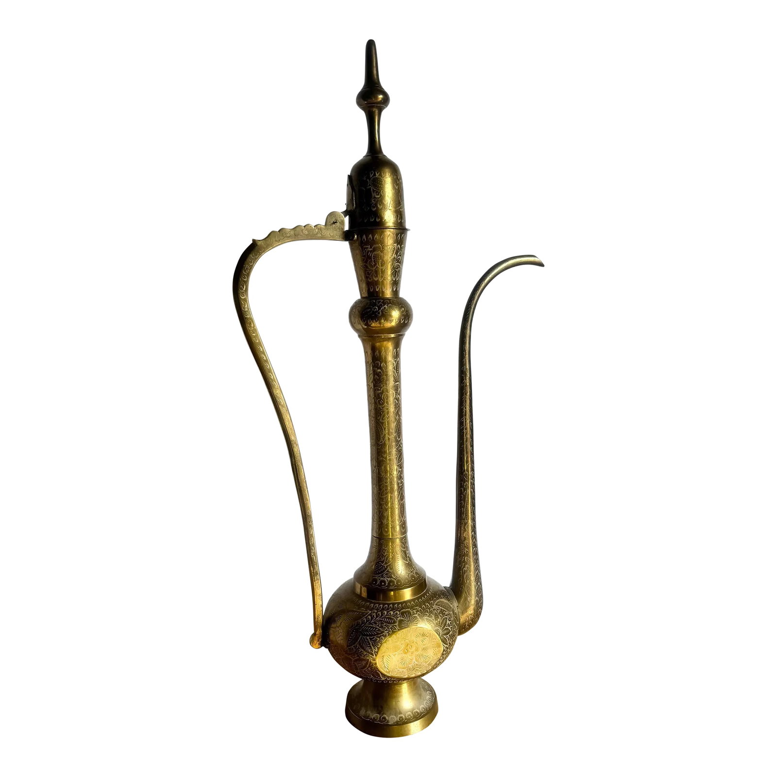 Mid 20th Century Moorish Etched Brass Pitcher/Ewer/Aftaba/Surahi: Richly detailed and beautifully patinated, this ornate Moorish brass ewer showcases intricate hand-etched floral motifs and an elegant elongated spout and handle. Its sculptural silhouette evokes Old