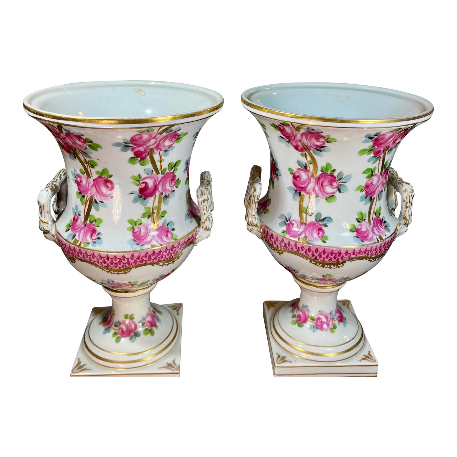 Antique Pair of Dresden Rose Porcelain Urns: Antique pair of Dresden porcelain urns featuring enameled pink rose depictions alongside gilt accents, double loop handles, and flared rims. Hallmarks to the undersides "D".. Condition: Alterations: