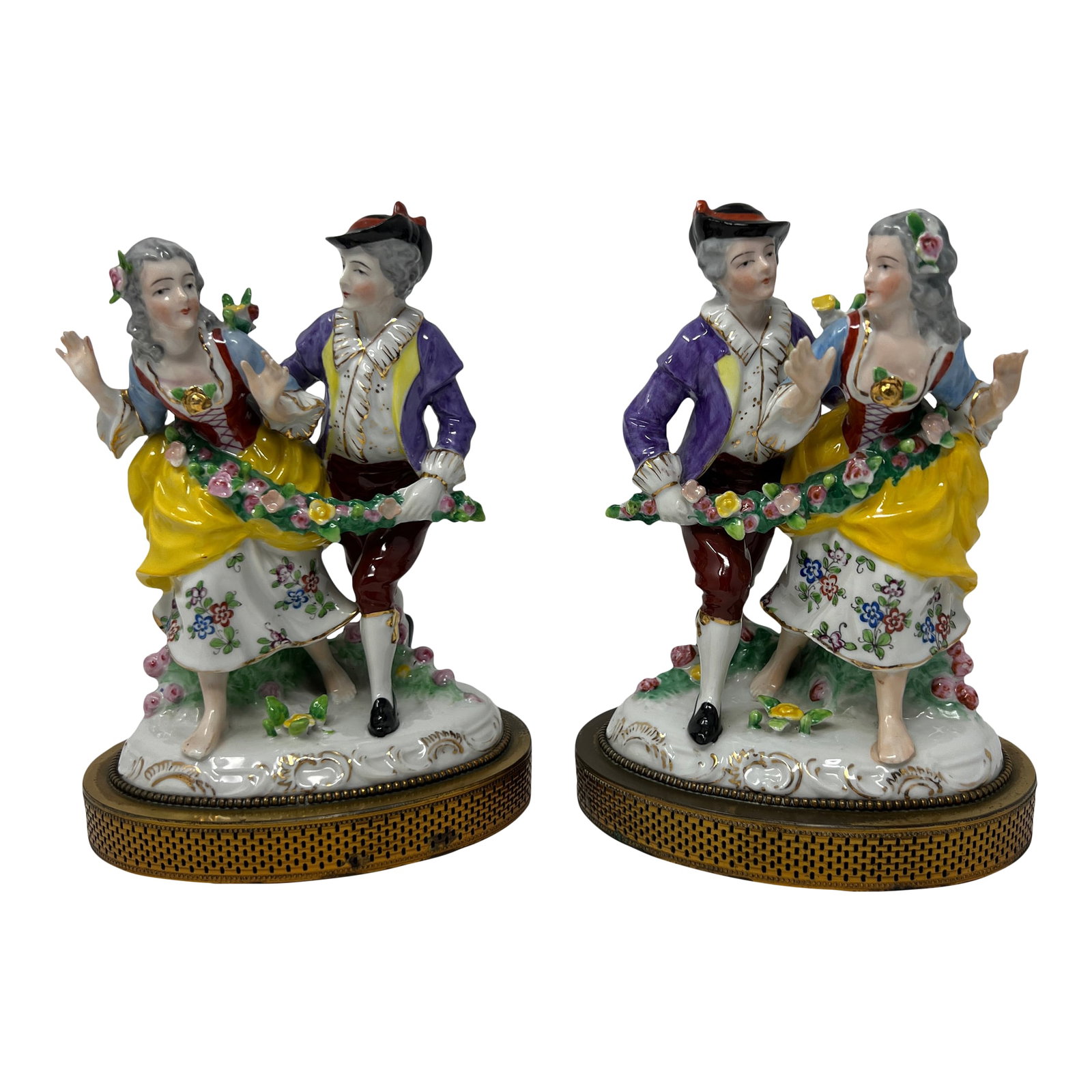 Pair of Dresden Style Porcelain Courting Couple Figurines on Pierced Metal Bases, Circa 1900: A charming matched pair of Dresden-style porcelain courting couples, circa 1900, modeled in the Rococo revival taste with expressive hand-painted faces, vivid enamel coloration, applied floral