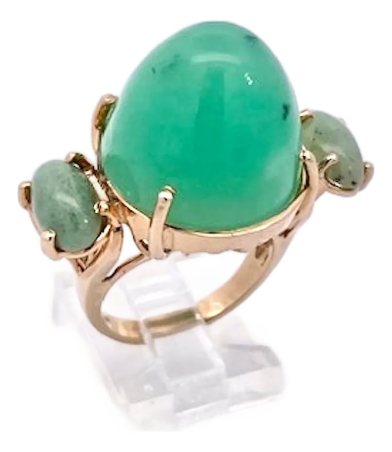 Chrysoprase Bullet Ring, Size 7: This one-of-a-kind Chrysoprase Bullet Ring is crafted in 14K yellow gold, featuring a breathtaking 34-carat center stone flanked by two elegant jade side stones. Bullet-cut gemstones are