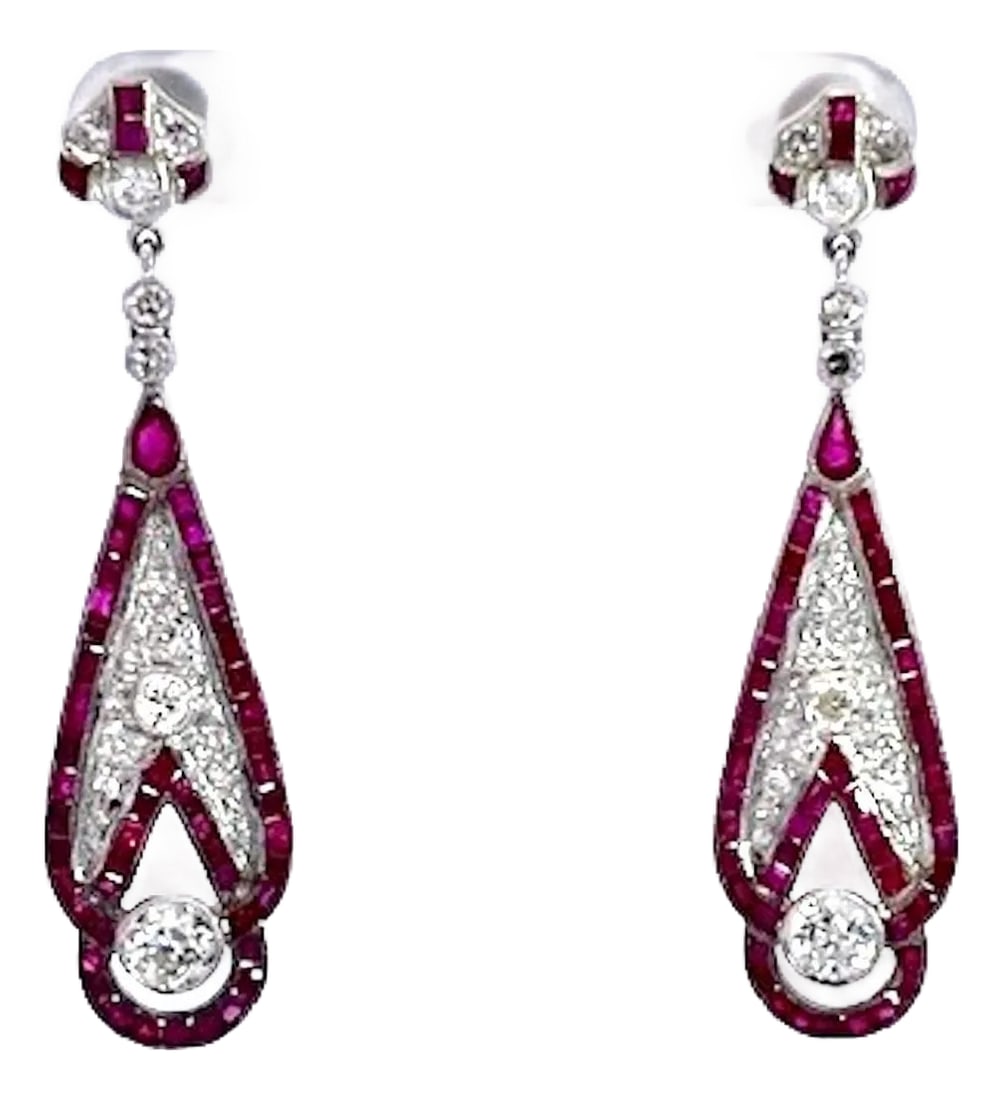 1990s Pair of Art Deco 18k White Gold Ruby Diamond Drop Earrings, 2" Length: These stunning Art Deco-inspired drop earrings feature an elegant elongated teardrop silhouette set in gleaming white gold or platinum. Vivid ruby baguettes form a bold geometric border, framing a