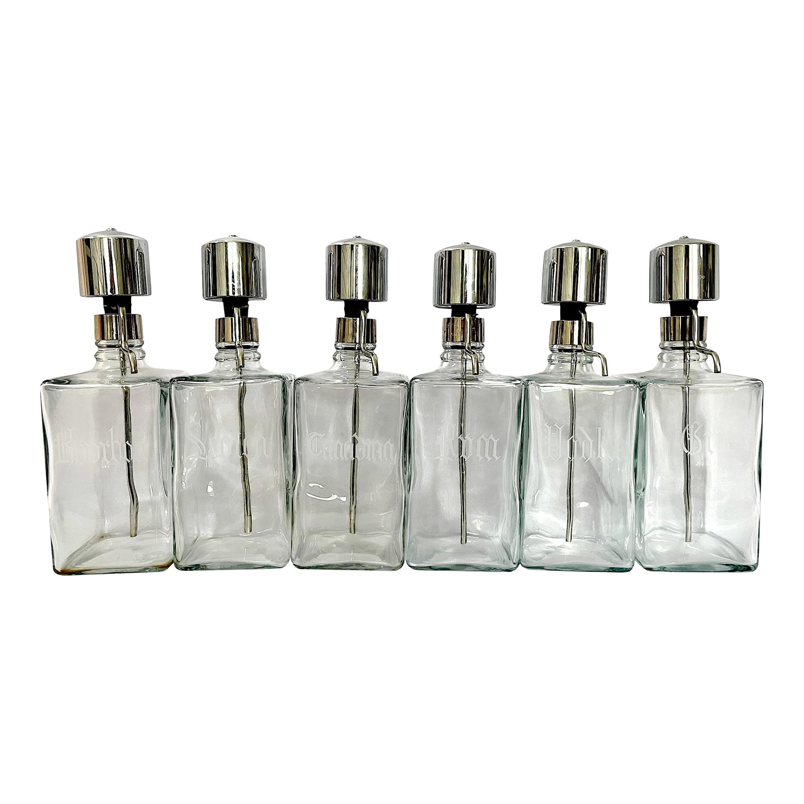 Vintage Mid-Century Etched Glass & Chrome Liquor Dispenser Bar Bottles "” Set of 6: A striking and increasingly hard-to-find set of six vintage glass liquor dispensers with polished chrome pour tops and etched Gothic lettering identifying each spirit: Vodka, Gin, Scotch, Rum,