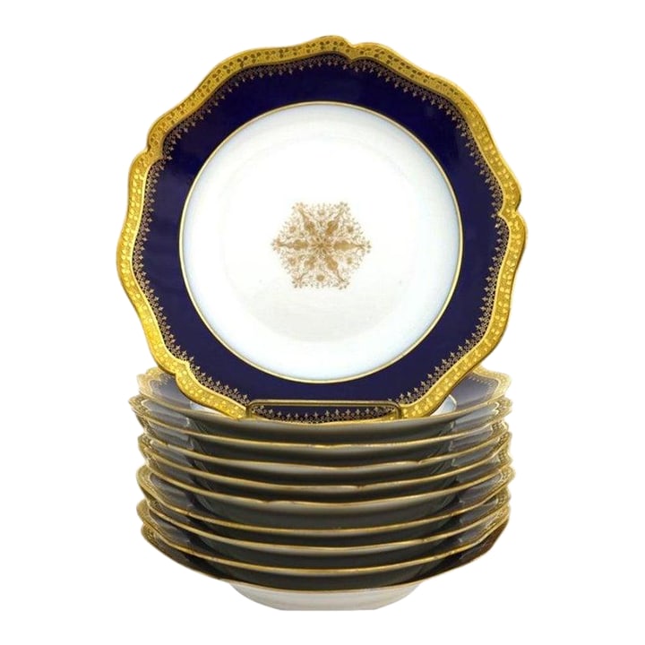 Ten French Limoges Cobalt Blue Porcelain Soup Bowls With Gold Trim C1900: This exquisite set comprises of ten antique French Limoges porcelain soup bowls, dating to approximately 1900. Each bowl features a rich cobalt blue border adorned with intricate gilded patterns,