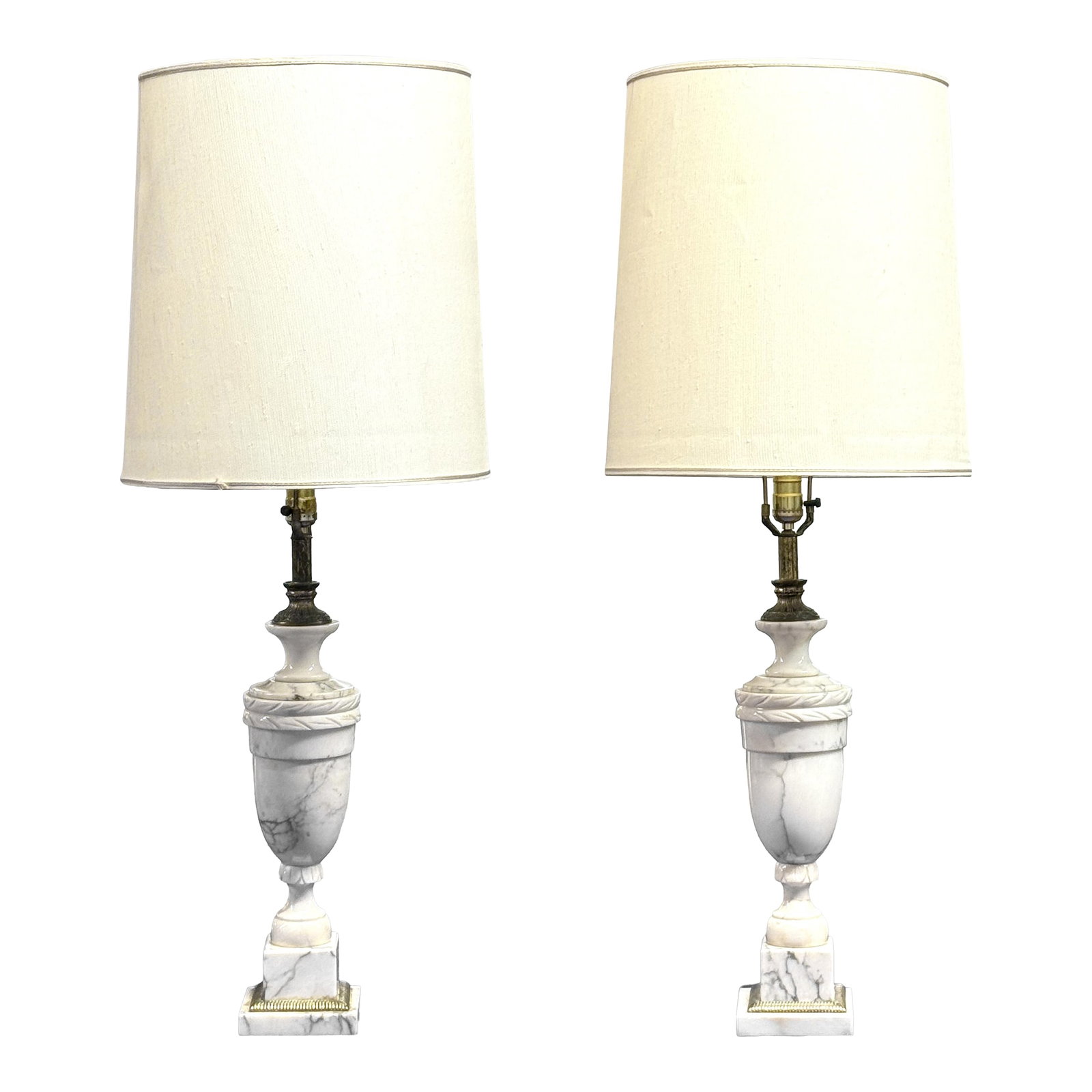 Pair of Vintage Italian Neoclassical White Marble Urn Table Lamps With Carved Details: Elevate your interiors with this striking pair of vintage Italian neoclassical marble urn table lamps. Crafted from heavy, high-quality white marble with elegant gray veining, these classic urn-form