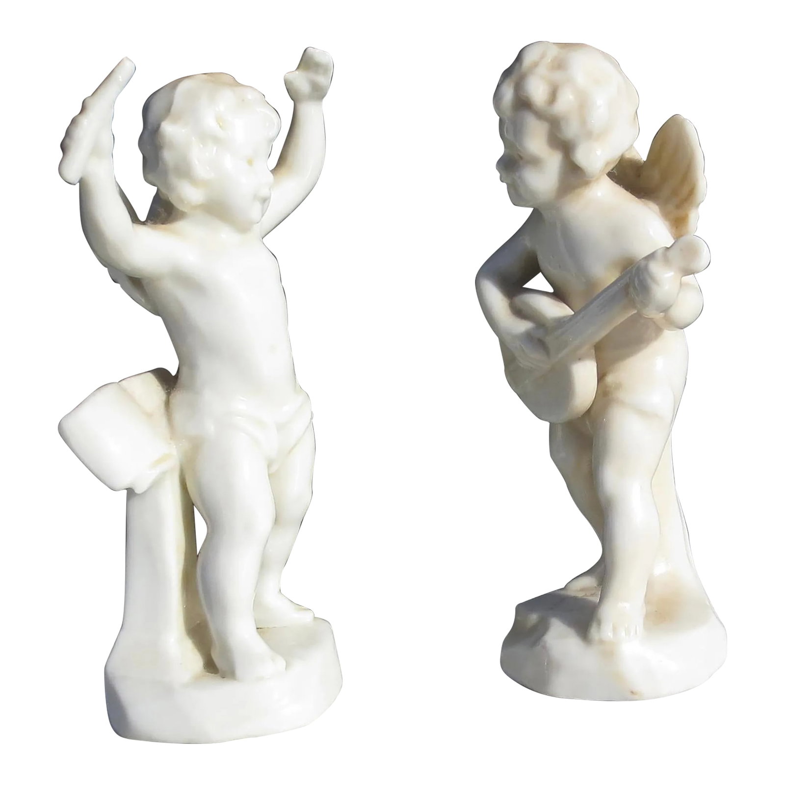 Pair of German Porcelain Putti Musicians - a Pair of 2: Two porcelain putti musicians. German porcelain with great details and lively actions, playing the lute and conducting. Marked to the base of each Germany and serial numbers. The measurements are
